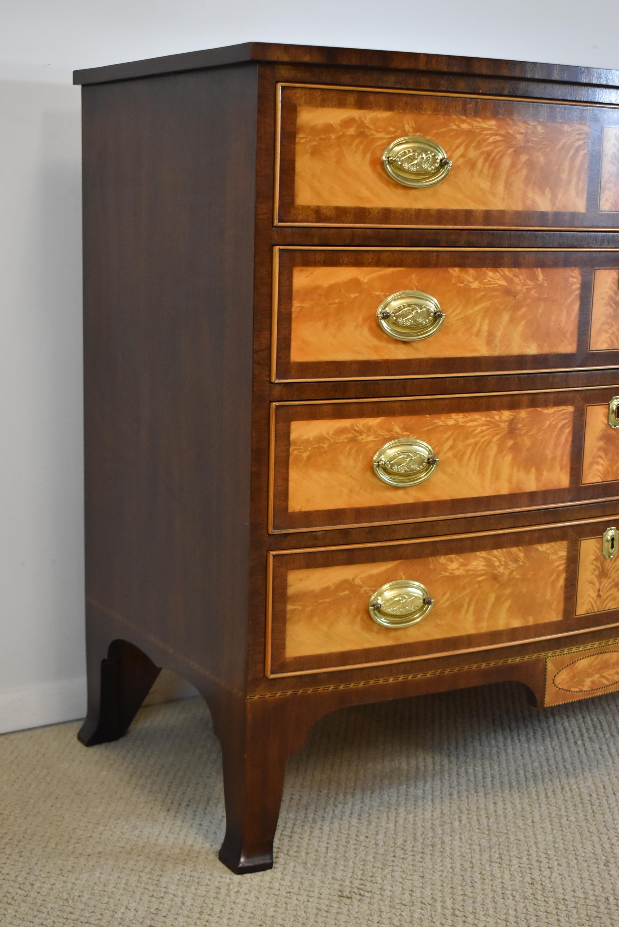 Henkel Harris Rogers chest, bow front, with mahogany and satinwood banded drawers. #2410. This chest is a rare find and is in great condition. It has 4 drawers and brass oval hardware with eagles. Happlewhite French splayed feet. Minor surface wear
