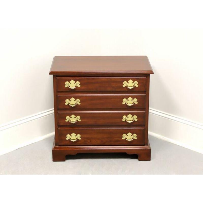 A Chippendale style chairside chest by Henkel Harris. Solid Wild Black Cherry with brass hardware, side handles and bracket feet. Features four drawers of dovetail construction. Made in Winchester, Virginia, USA, circa 1991. 

Style #: 5417, Finish