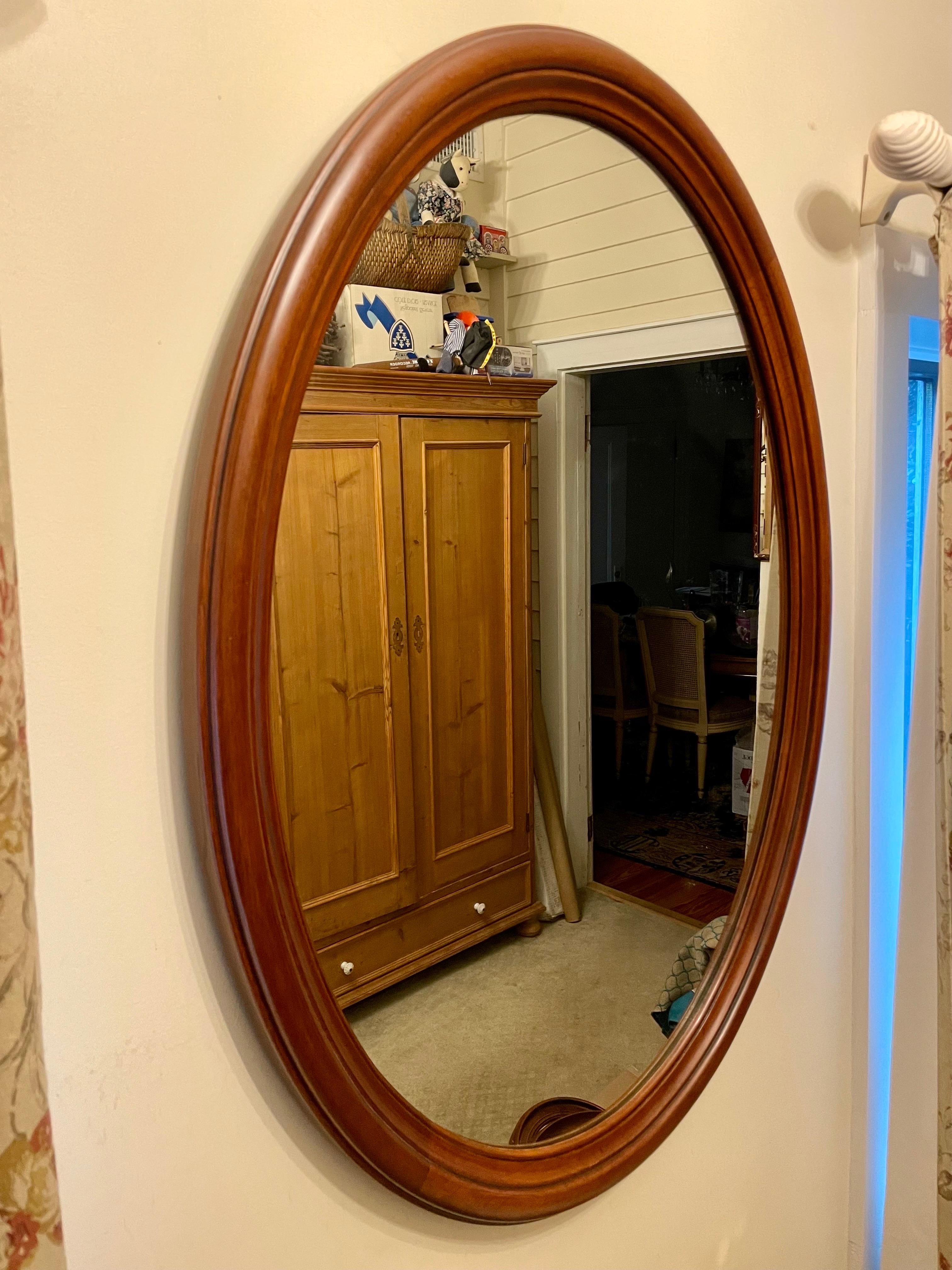 Henkel Harris Wild Black Cherry Oval Wall Mirror with stylized deep ogee profile and inside edge bead.  Wire on back for hanging. Tag on back: Virginia Galleries, The Henkel-Harris Co. Winchester Virginia, Finish No. 24, Style 154, Shop 581-636.
