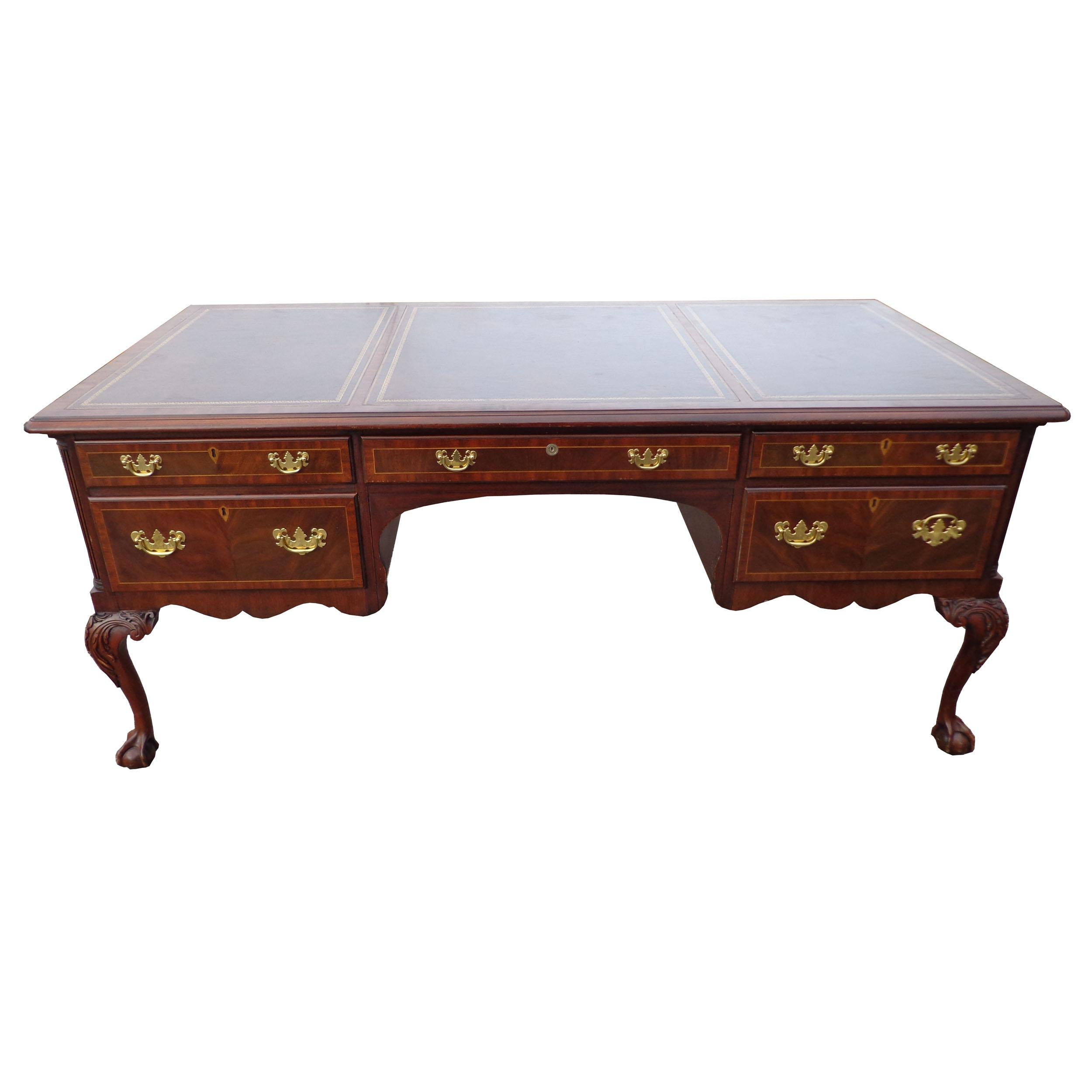 Henkel moore Chippendale mahogany leather top ball and claw executive desk

Tooled leather inlay top. Brass pulls.
Carved ball & claw feet.
6 dove tailed drawers with locking mechanism and brass pulls.
3 pull out work tablets.
Finished back