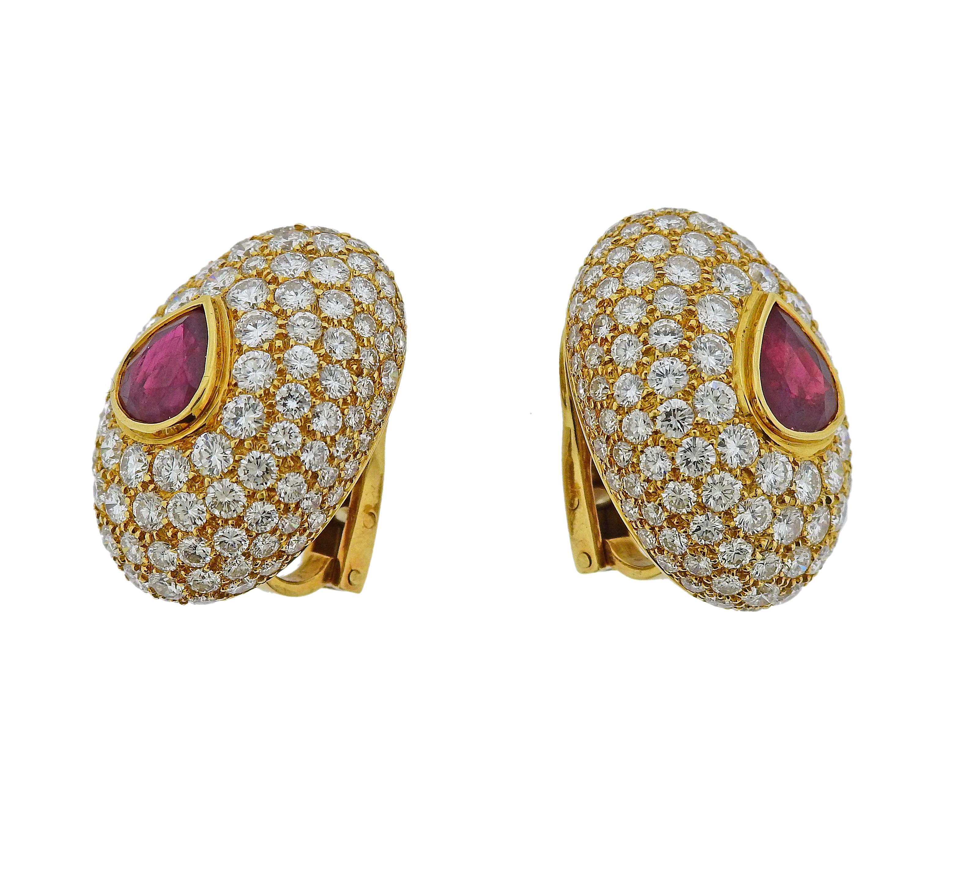 Pair of impressive Hennell 18k god earrings, set with two rubies in the center (approx. 6 carats total) surrounded with a total of approx. 15 carats in G/VS diamonds. Earrings are measured 27mm x 19mm. Weight is 17.5 grams. Marked: Hennell, SGD.