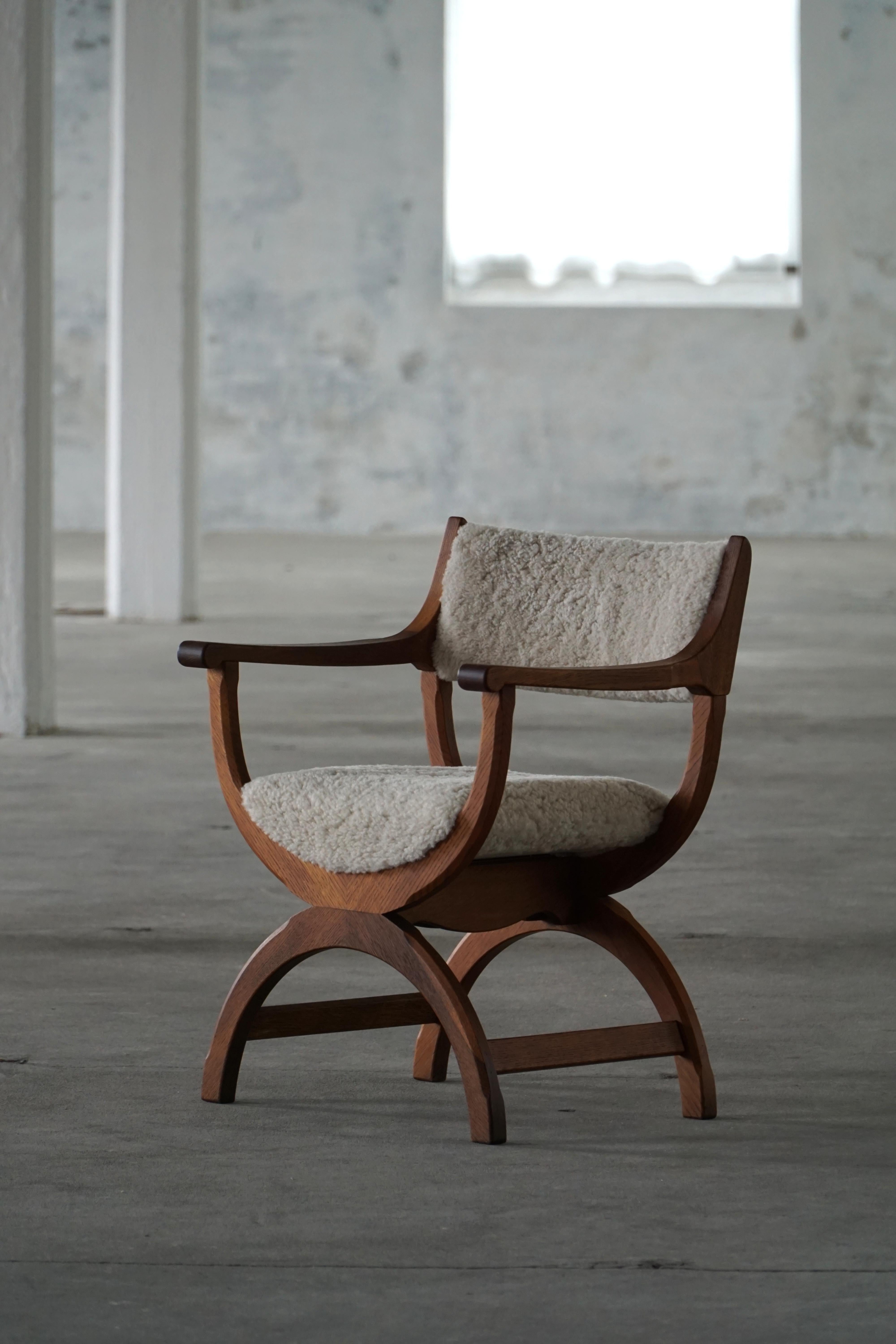 A fine and elegant armchair in solid oak, reupholstered in quality shearling lambswool. Designed by Henning (Henry) Kjærnulf for EG Kvalitetsmøbel, Denmark 1960s. Model 