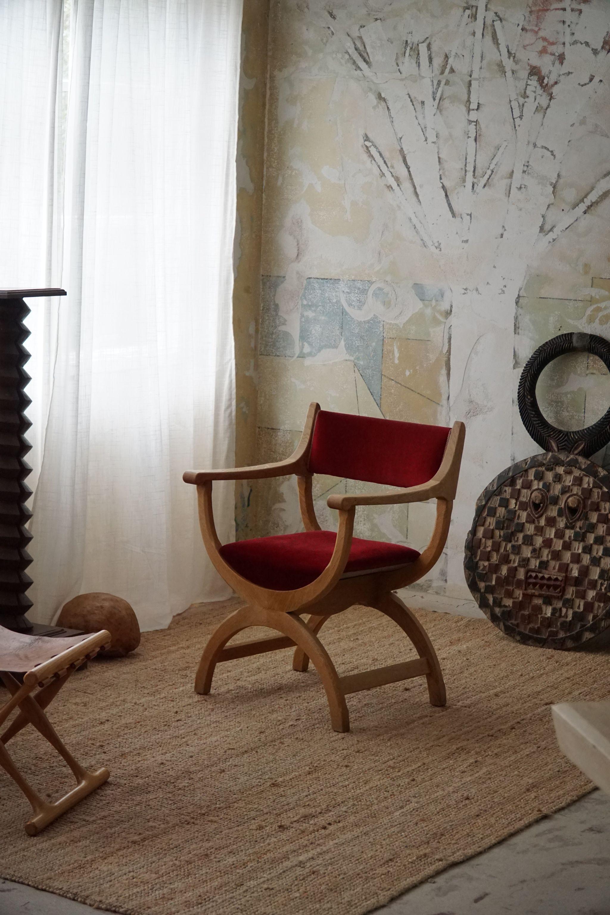 A fine and elegant armchair in solid oak upholstered in a decadent red velvet. Designed by Henning (Henry) Kjaernulf for EG Kvalitetsmøbel, Denmark 1960s. Model 