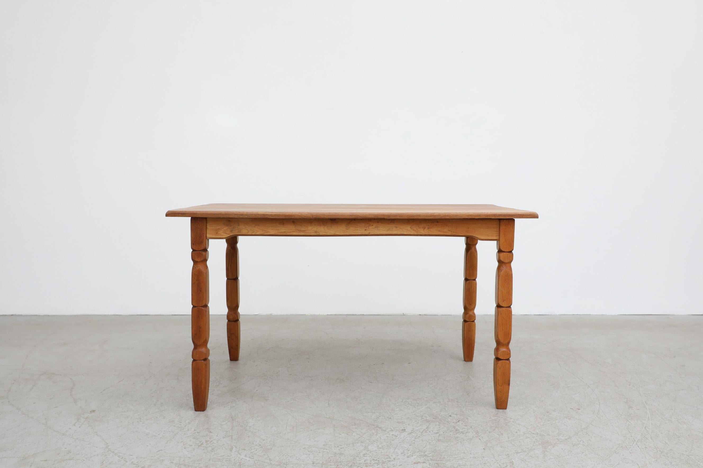 With its uniquely carved legs and brutalist style, this dining table is attributed to Henning Kjaernulf. Shown with matching Brutalist Oak Arm Chair, listed separately (S836A RK). The dining table is in original condition, with normal wear and