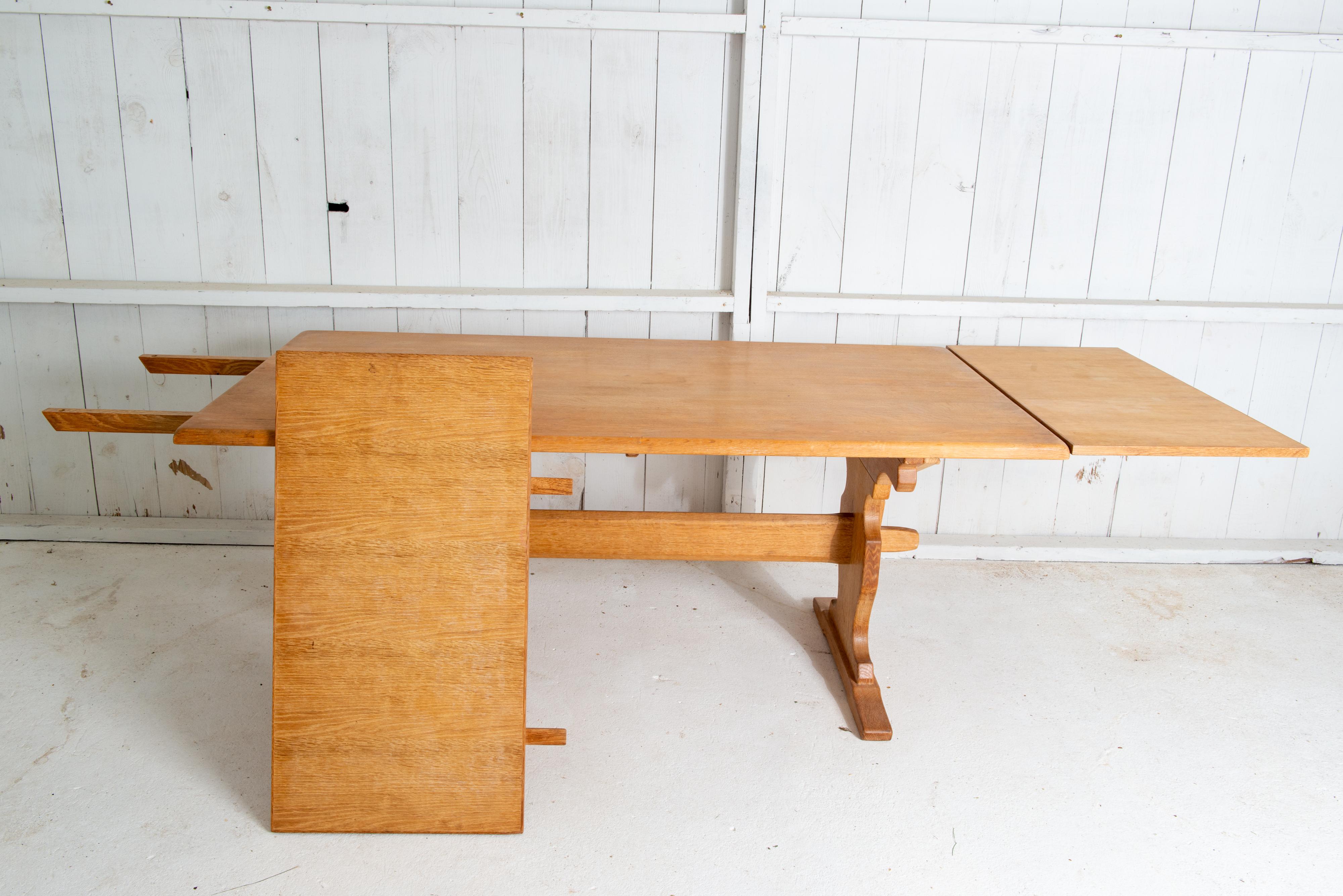 This is a stunning solid quarter sawn white oak Danish trestle dining table attributed to Henning Kjaernulf. The 104