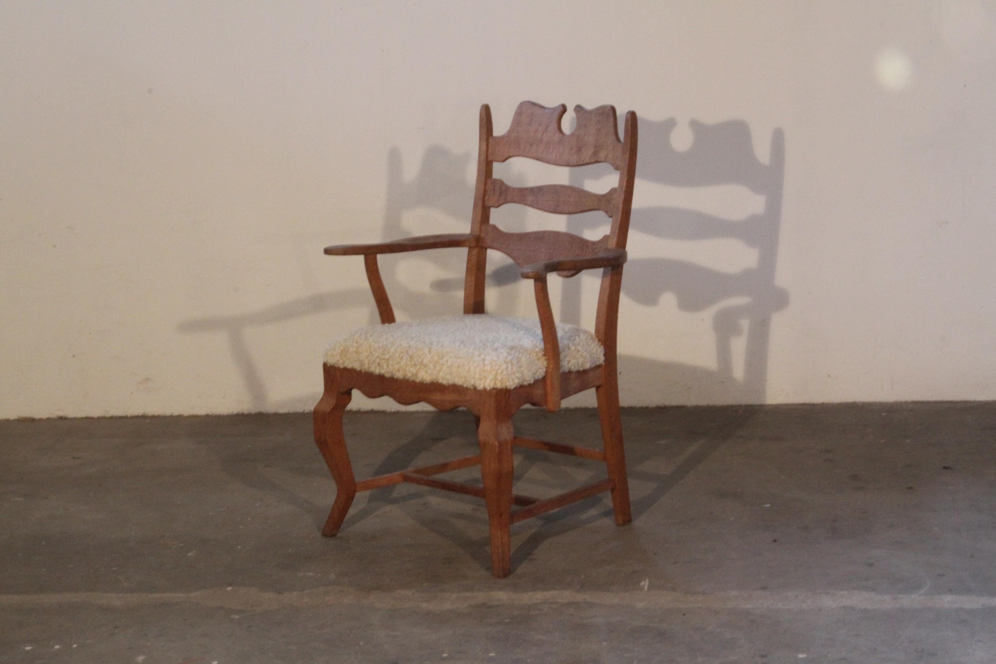 Henning Kjaernulf brutalist oak armchair in a unique razorback throne style. Designed by the renowned Danish designer, this chair with seats newly upholstered in soft lambswool.

The oak wood has a deep patinated oak color, which only time can