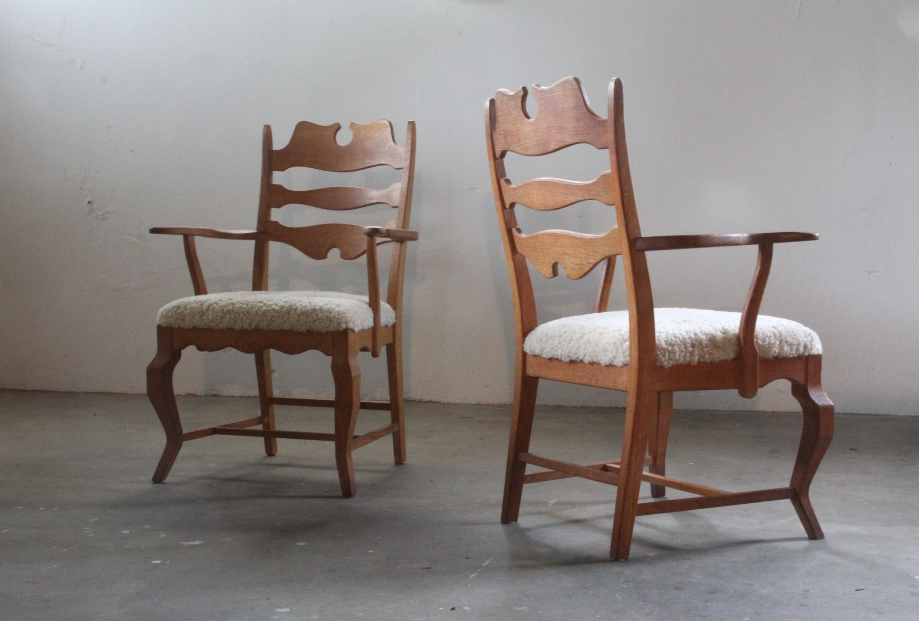 Un par de sillones brutalistas de roble Henning Kjaernulf restaurados, con un estilo único de trono razorback. Diseñadas por el célebre diseñador danés, estas sillas han sido cuidadosamente renovadas, con asientos recién tapizados en suave lana de
