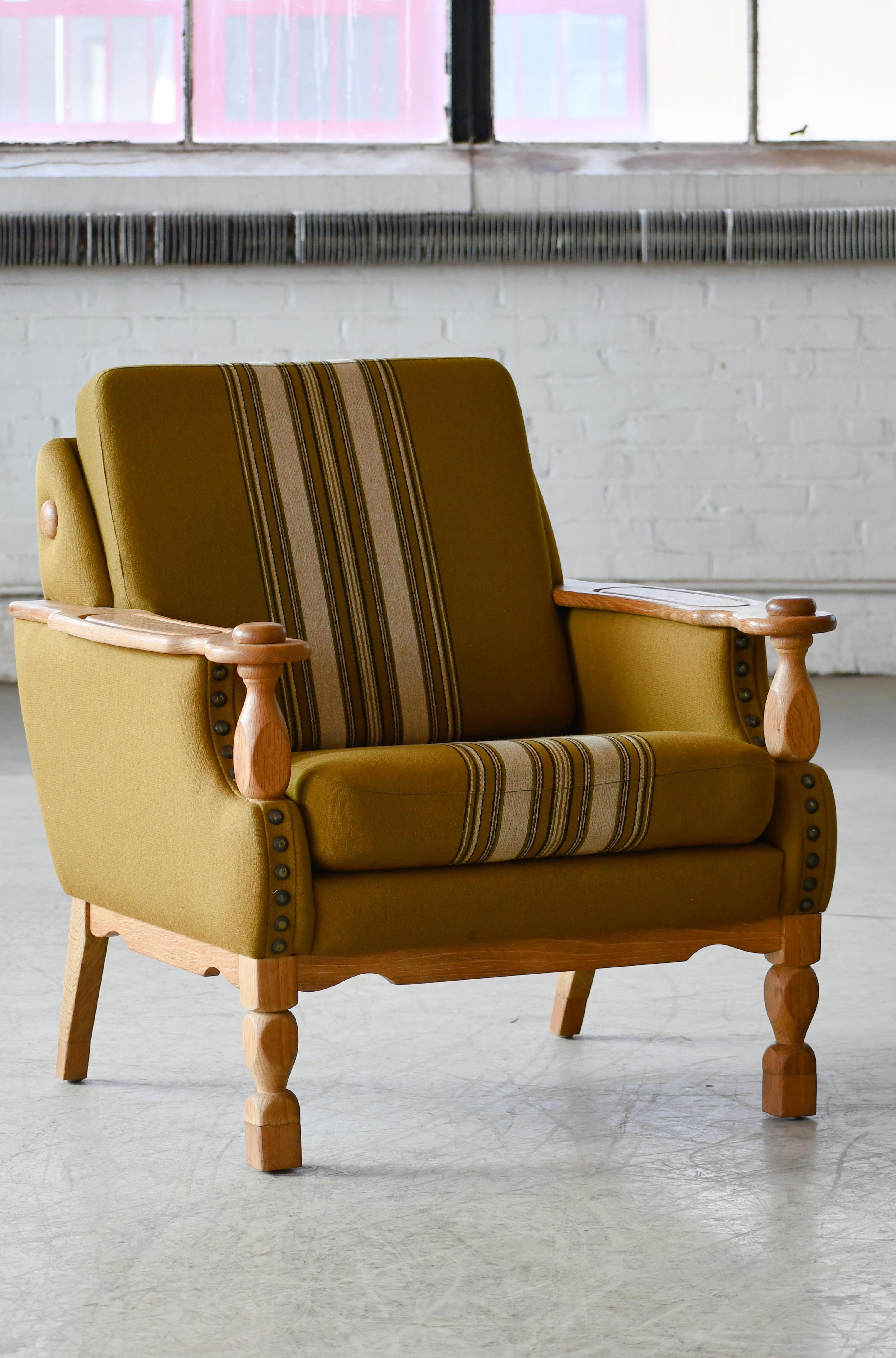Rare and sought after lounge chair by Danish Designer, Henning Kjaernulf made from quarter-sawn white oak and hand carved in brutalist style seeking inspiration from art & crafts and even Jacobean styles. Kjaernulf's style is very unique and