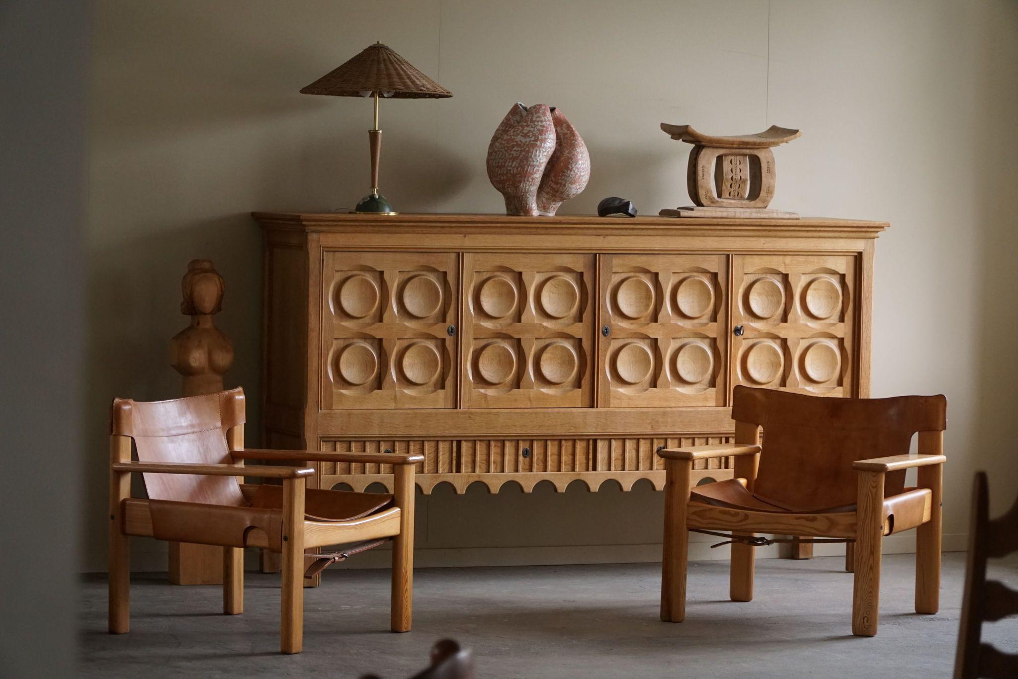 A classic rectangular sideboard / cabinet in oak with plenty of storage and a nice carved front design. Designed by Henning (Henry) Kjærnulf for Nyrup Møbelfabrik in the 1960s. Crafted from oak, the sideboard features a robust and imposing presence,