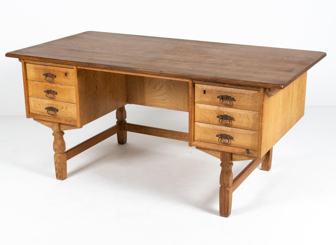 Give your office some modern farmhouse flair with this Danish mid-century desk in carved oak by Henning Kjaernulf. Designed with Kjaernulf's characteristic amalgamation of Baroque-inspired carvings with contemporary appeal, this Scandinavian