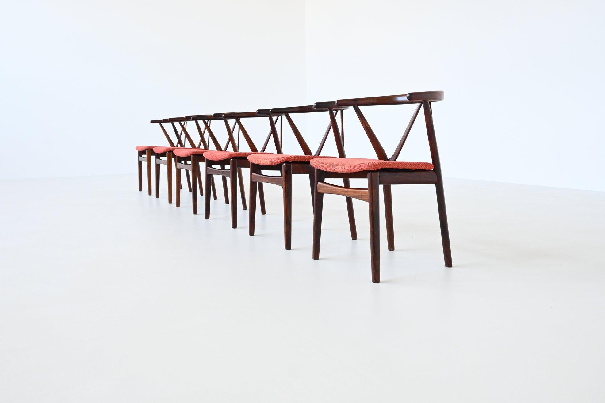 Amazing rare set of six dining chairs model 255 designed by Henning Kjaernulf for Bruno Hansen, Denmark 1960. These dining chairs showcases the refined artistry of mid-century Danish design.

Crafted from rich rosewood, each chair is distinguished