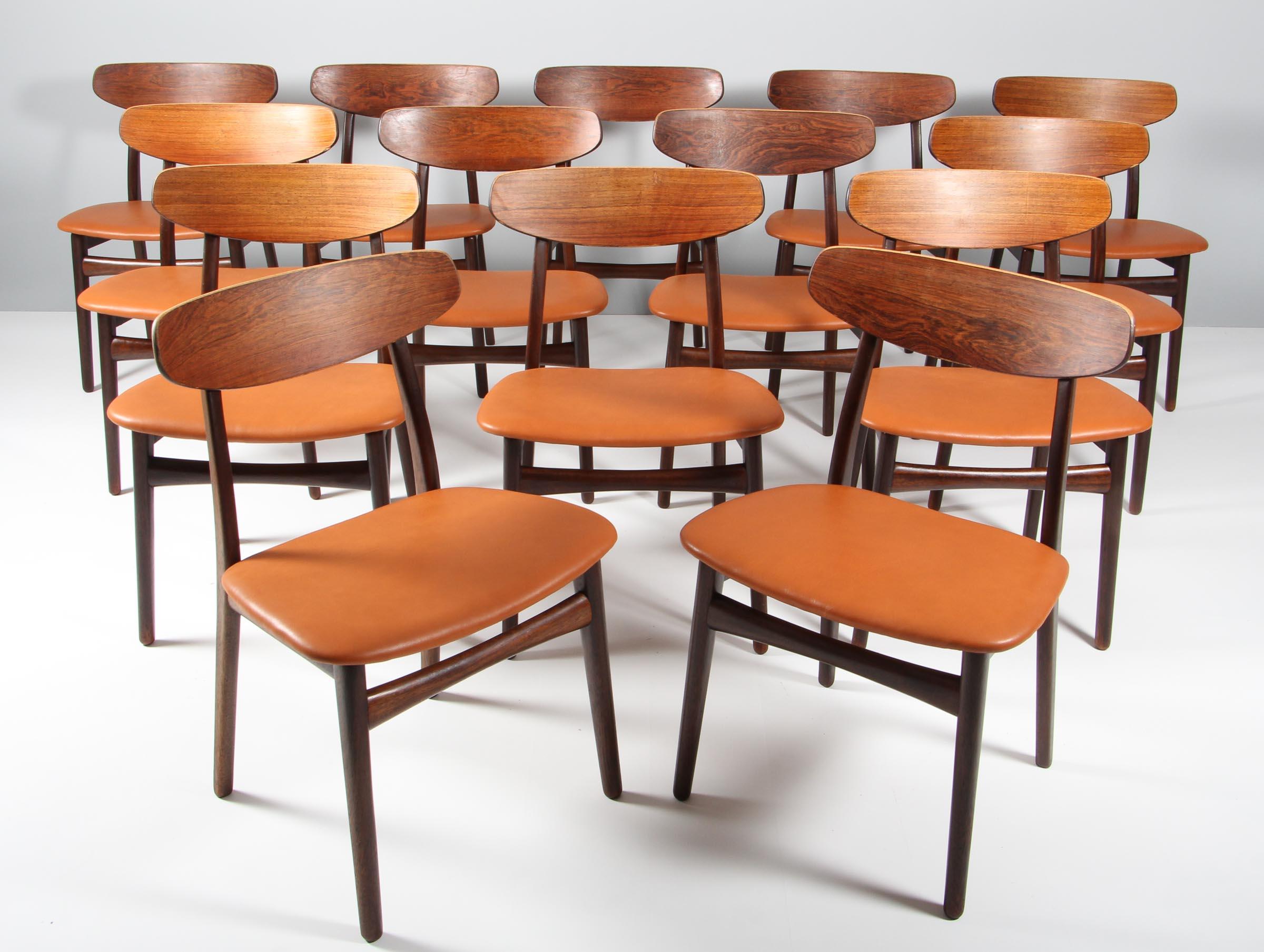 Henning Kjærnulf dining chairs, upholstered with tan aniline leather.

Frame of solid rosewood.

Made by Bruno Knudsen.