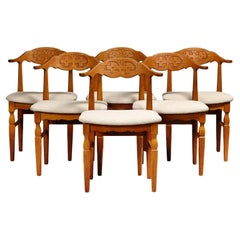 Henning Kjærnulf dining chairs set in Oak and Off White Bouclé, Denmark, 1960s