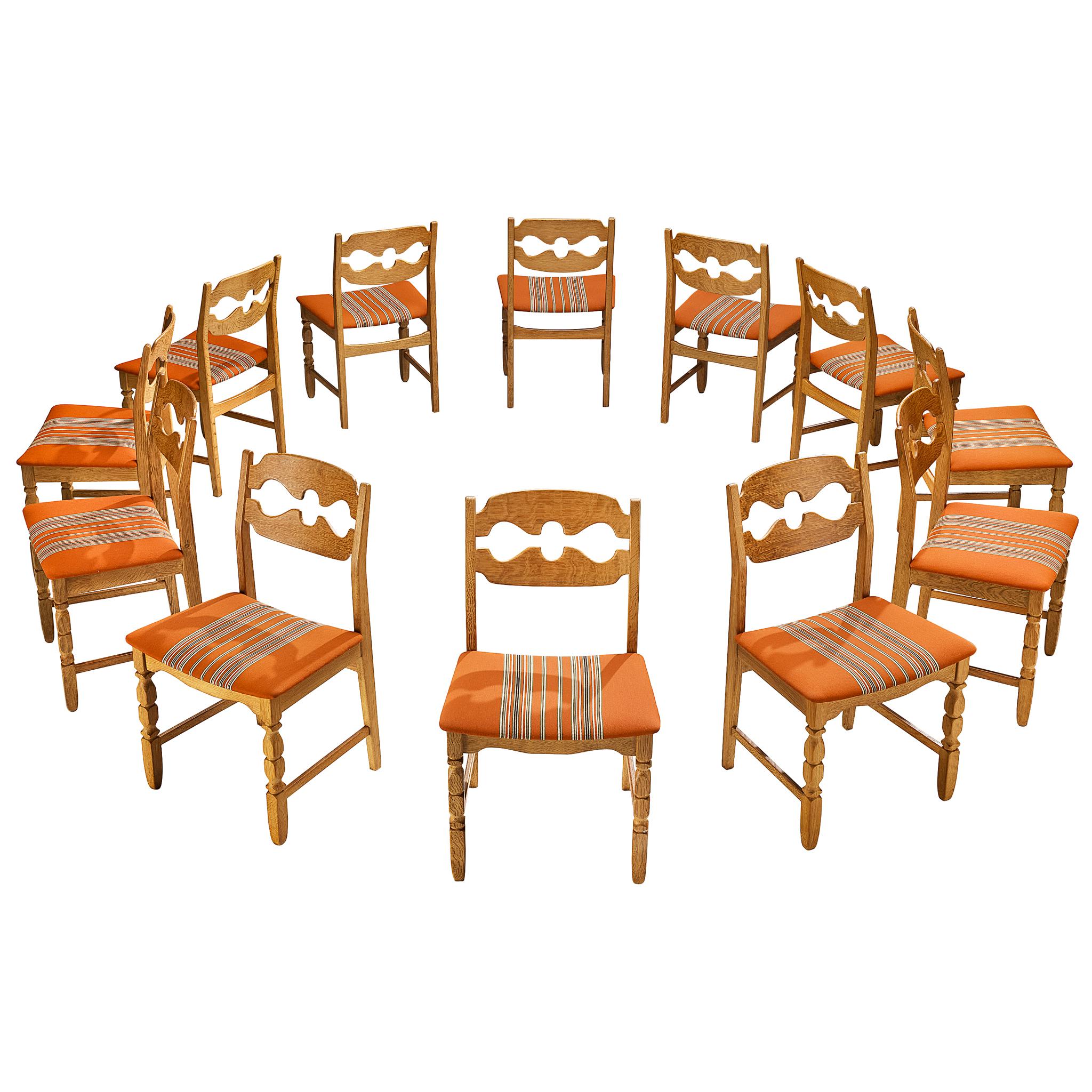 Henning Kjærnulf for Nyrup Møbelfabrik Set of Twelve Carved Dining Chairs in Oak For Sale