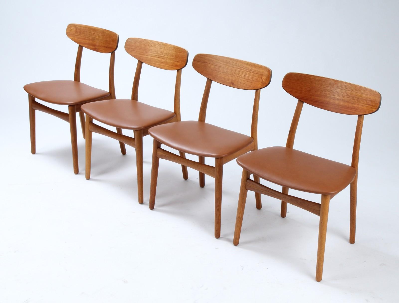 Four dining chairs with cup piece in teak, frame in solid oak, seat newly upholstered.
The 1960s. Made at Gunnar Schwartz Company, Los Angeles, stamped.