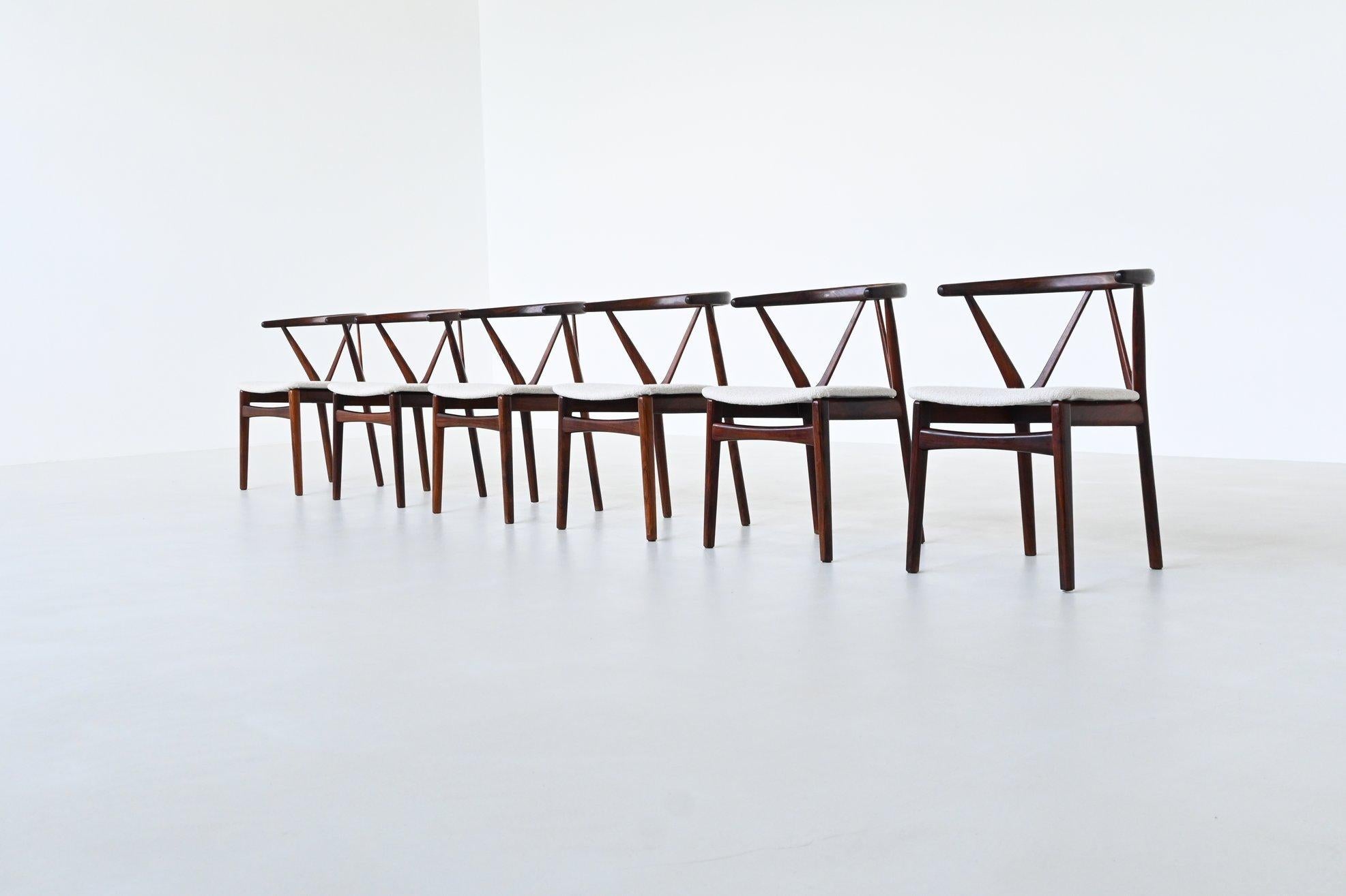 Amazing rare set of six dining chairs model 255 designed by Henning Kjaernulf for Bruno Hansen, Denmark 1960. These dining chairs showcases the refined artistry of mid-century Danish design.

Crafted from rich rosewood, each chair is distinguished