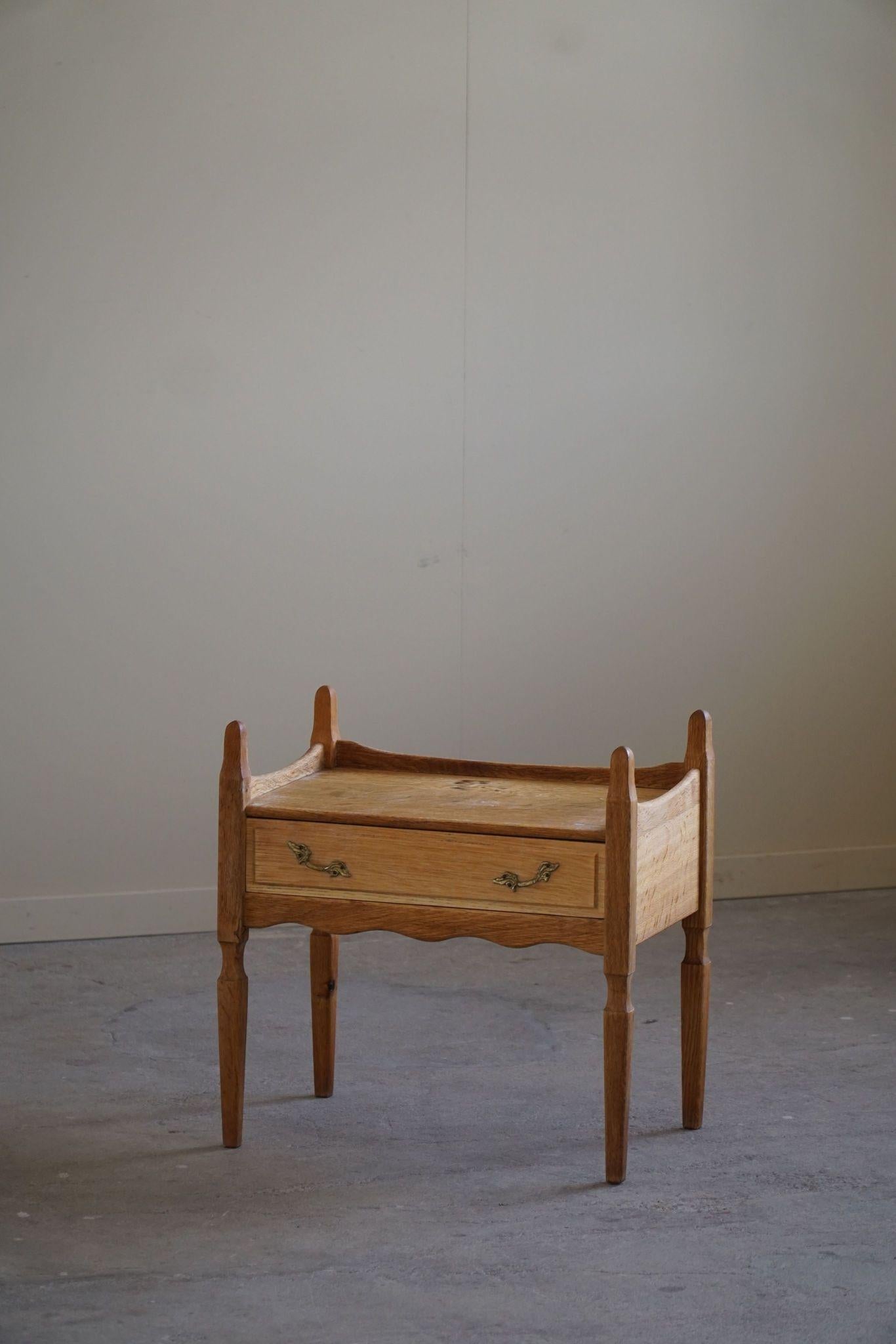 A gorgeous bed side table / chest of drawer in oak. Designed by Henning Kjærnulf in 1960s. Made by Nyrup Møbler. A rare sculptural object that combine baroque style and modernism. 

This fine piece will complement many interior styles. A modern,