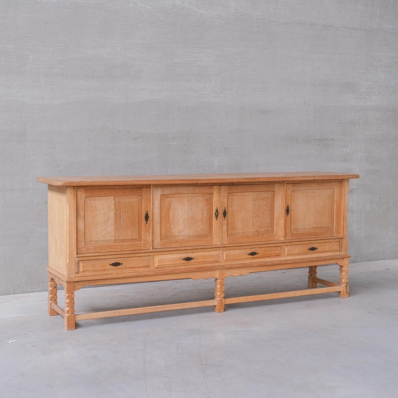 An oak sideboard by Henning (Henry) Kjaernulf.

Denmark, c1960s.

Cabinet doors over drawers.

Good vintage condition, some scuffs and wear commensurate with age.

Internal ref: 12/9/23/029.

Location: Belgium Gallery.

Dimensions: 91 H x 226 W x 50