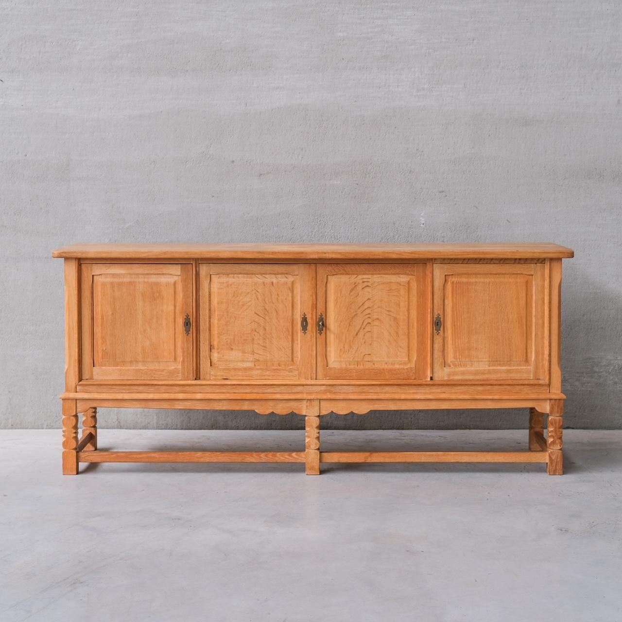 An oak sideboard by Henning (Henry) Kjaernulf.

Denmark, c1960s.

Four door cabinets.

The base separates from the top for transport.

Good vintage condition, some scuffs and wear commensurate with age.

Internal Ref: 18/10/23/044.

Location: London
