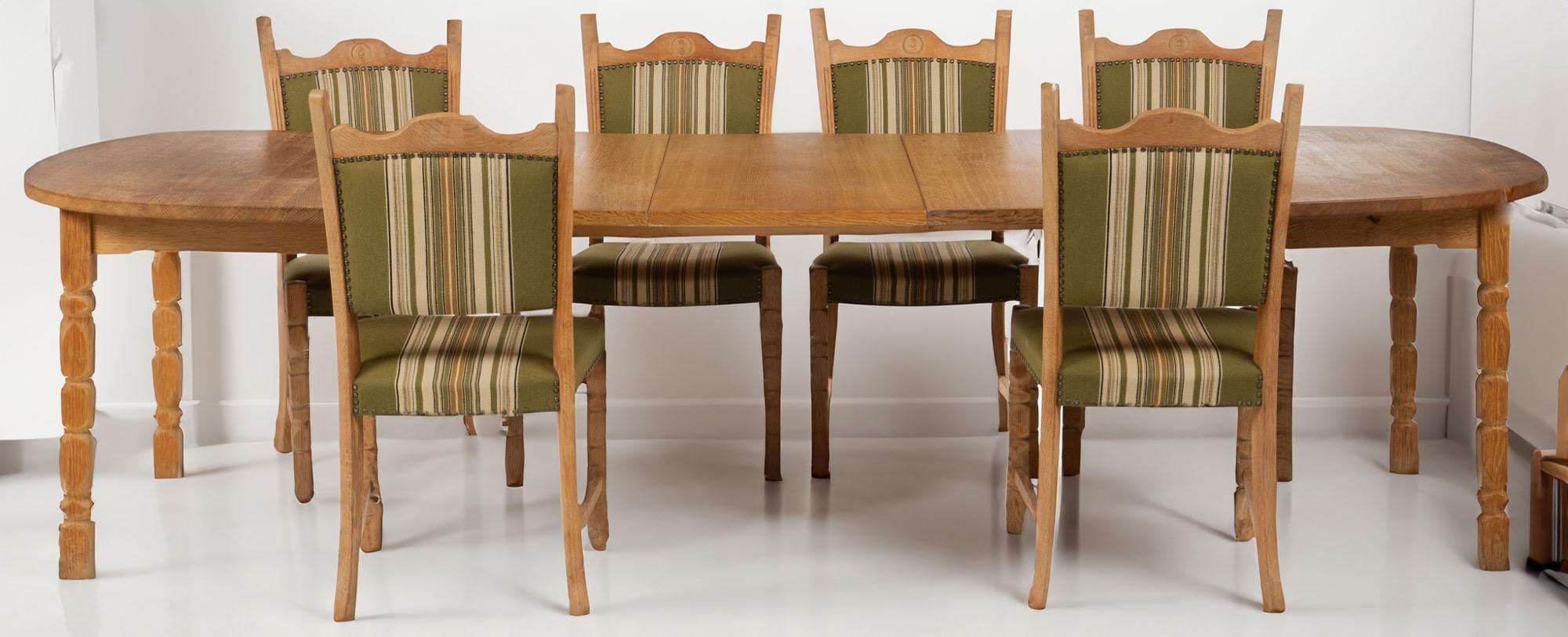 Danish modern brutalist rustic solid oak extendable dining table with 3 removable leaves and set of 6 oak dining chairs by Henning Kjærnulf features hand-crafted details with sculpted legs. With leaves, this dining table can easily fit 8-10 dining