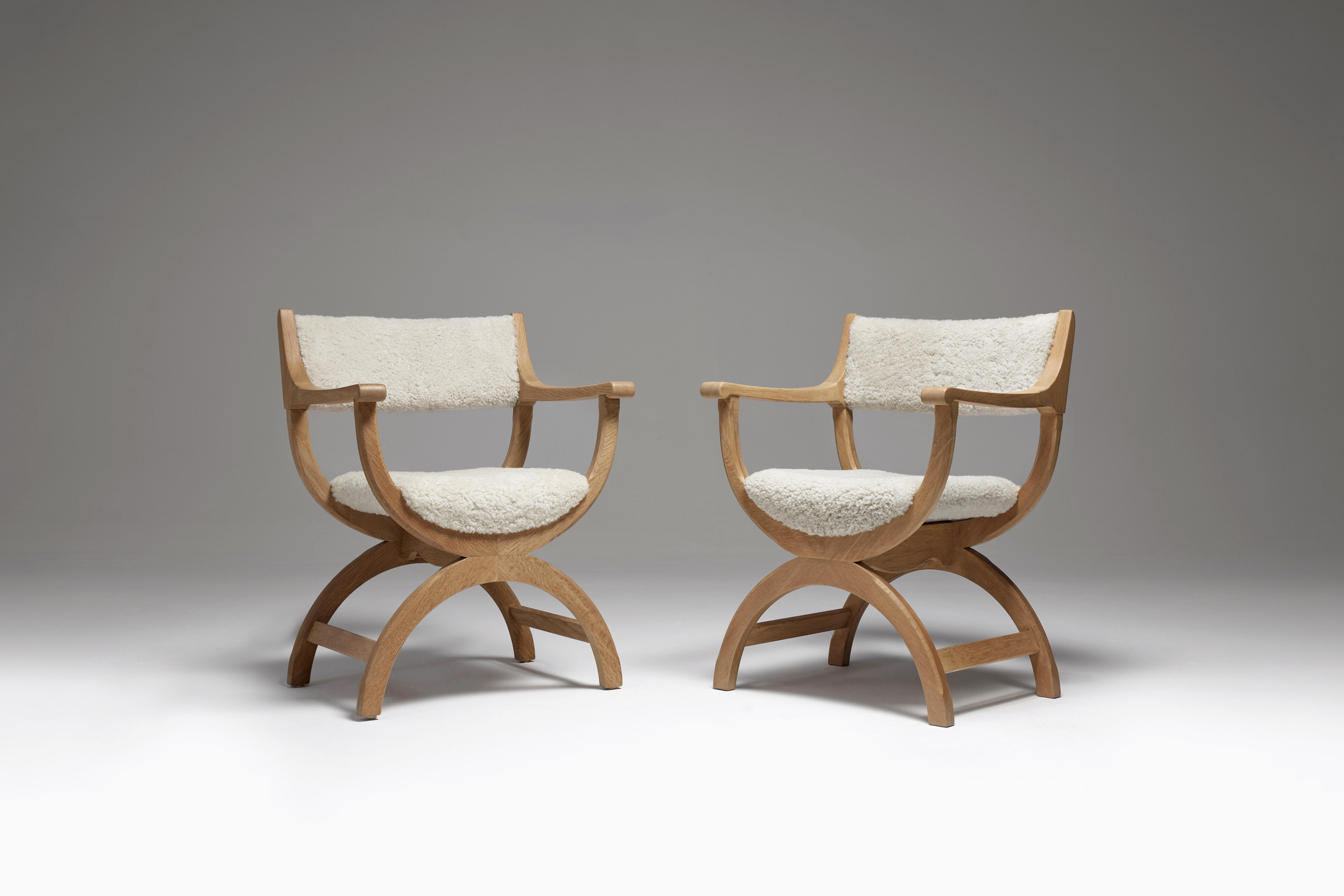 A pair of iconic chairs by Danish designer Henning Kjærnulf, often called the “kurulstol” or kurul chair. The Curule seat is a foldable and portable chair with curved legs, the roots of which go back to ancient Rome, where, apart from everyday uses,