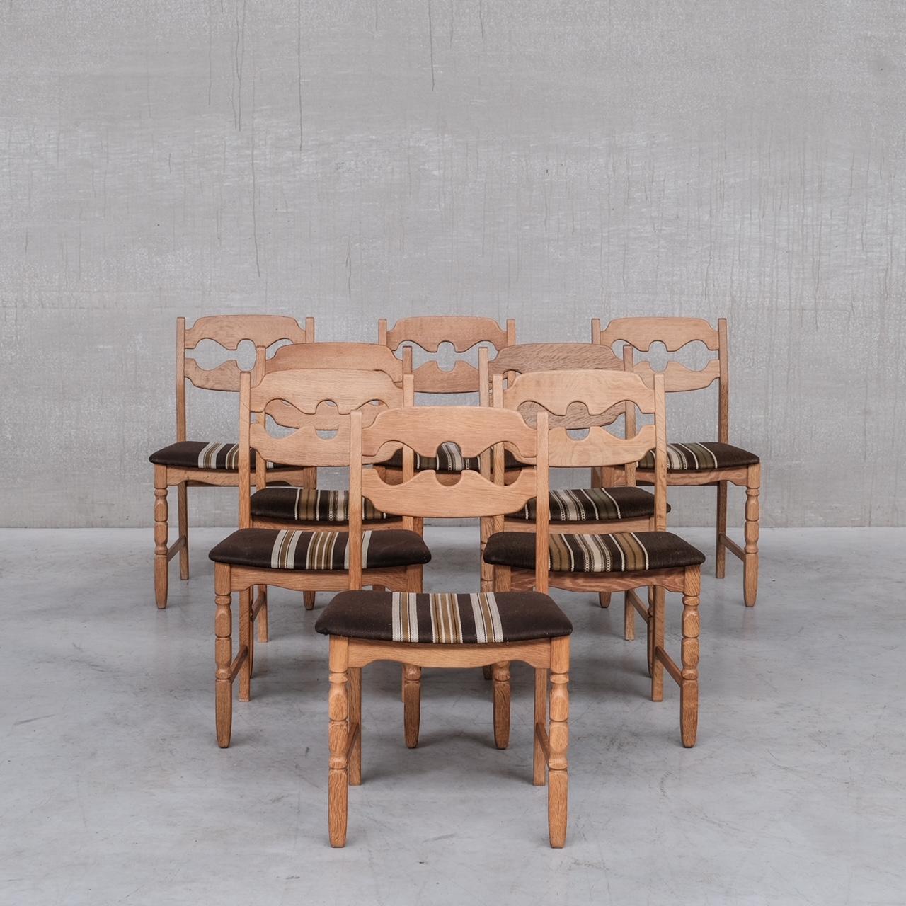 A set of oak dining chairs by Henning Kjaernulf. 

Denmark, c1960s. 

'Razor back' or 'Razor blade' model. 

Generally good condition for the wood, some wear and scuffs commensurate with age. The wood has been colour matched as these were two