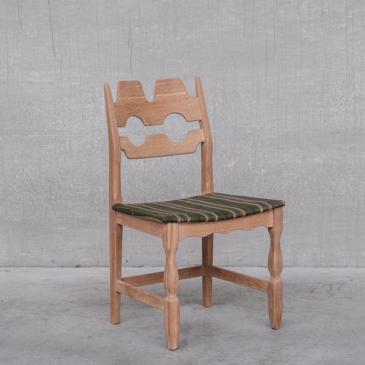 A set of dining chairs by Henning Kjaernulf. 

Denmark, c1960s. 

Increasingly scarce Razorback model. 

Oak, original upholstery retained but wants updating which is easily done. Formed from several sets, the wood has been colour matched so