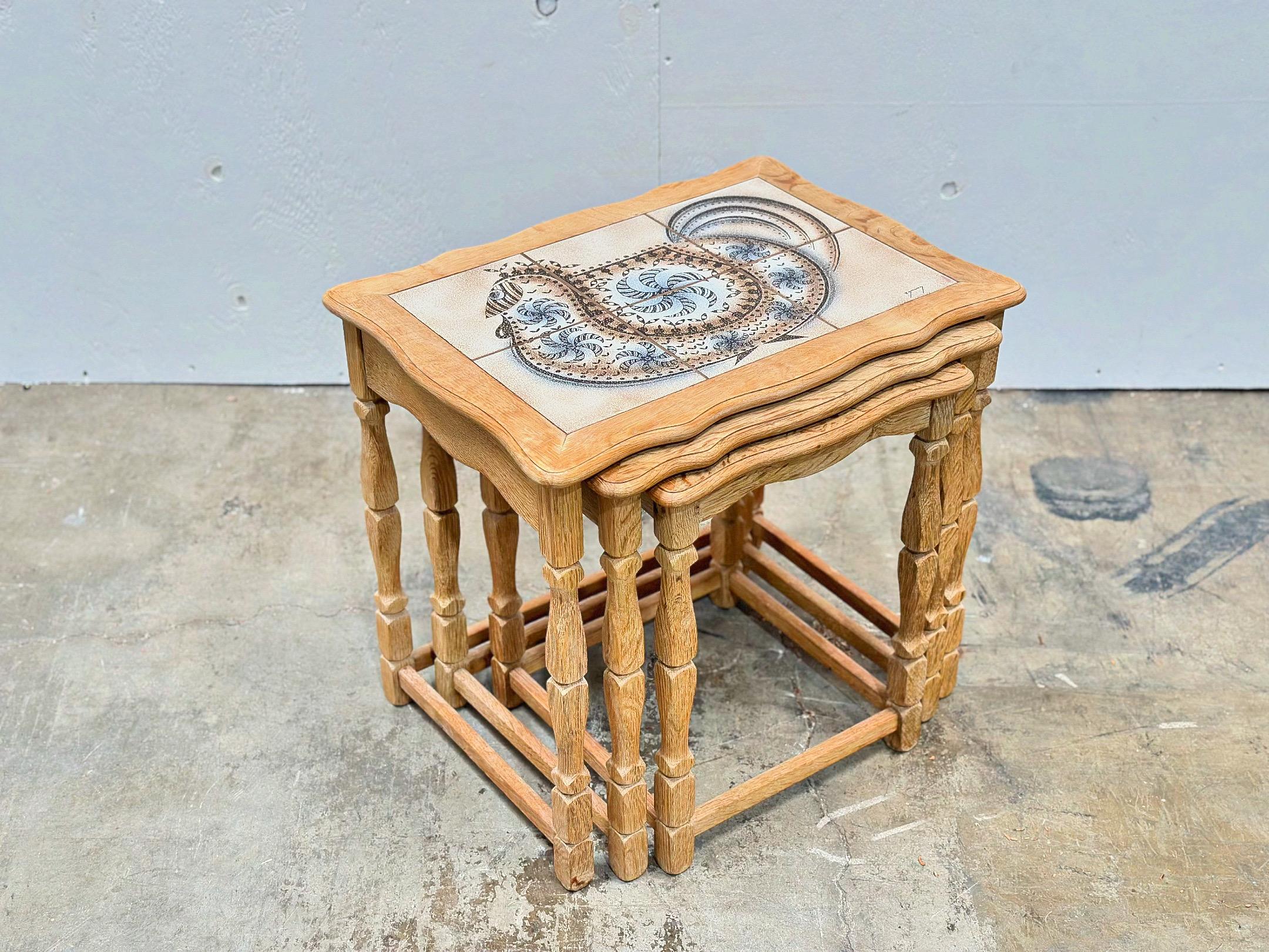 Danish modern nesting tables by Henning Kjærnulf for EG Kvaliteet, Denmark circa 1970s. Solid carved Scandinavian white oak with hand painted ceramic tiles by Edmund Pedersen.
Excellent condition with no issues of note. This set has been cleaned and