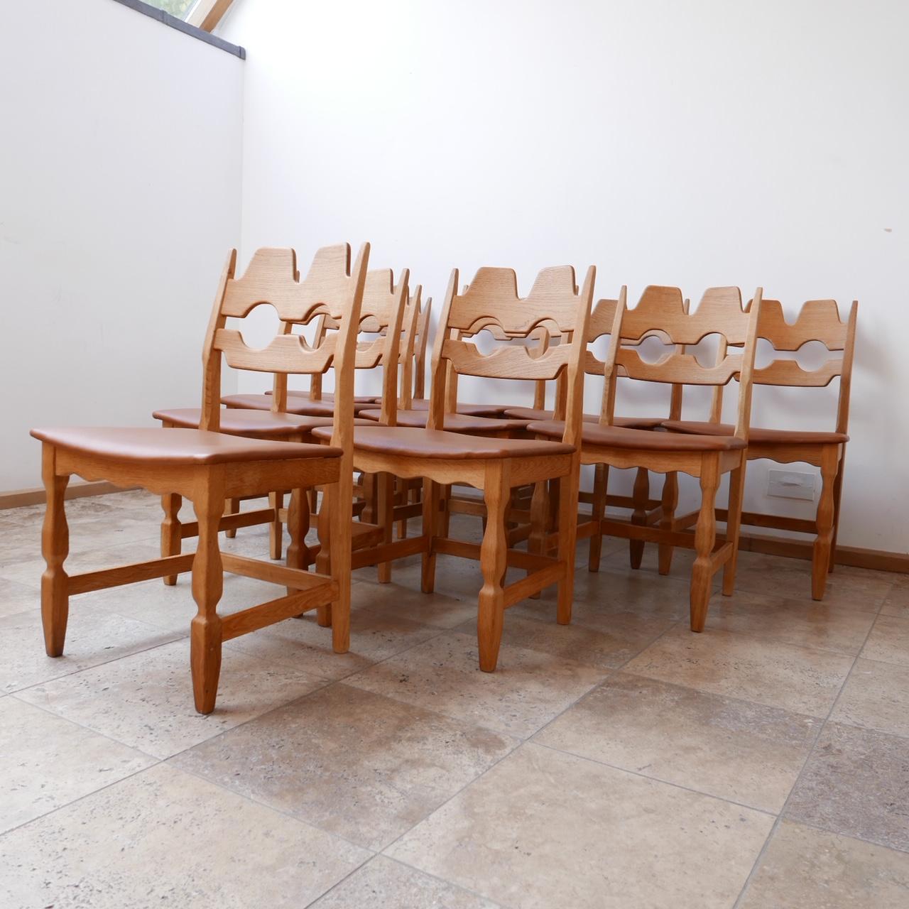 A run of dining chairs by Henning Kjærnulf.

Oak and tan leather. 

Razor blade style back. 

Denmark, c1960s, for EG Møbler.

Priced and sold individually.

Dimensions: 50 W x 45 D x 44 seat height x 84 total height in cm.

Delivery: