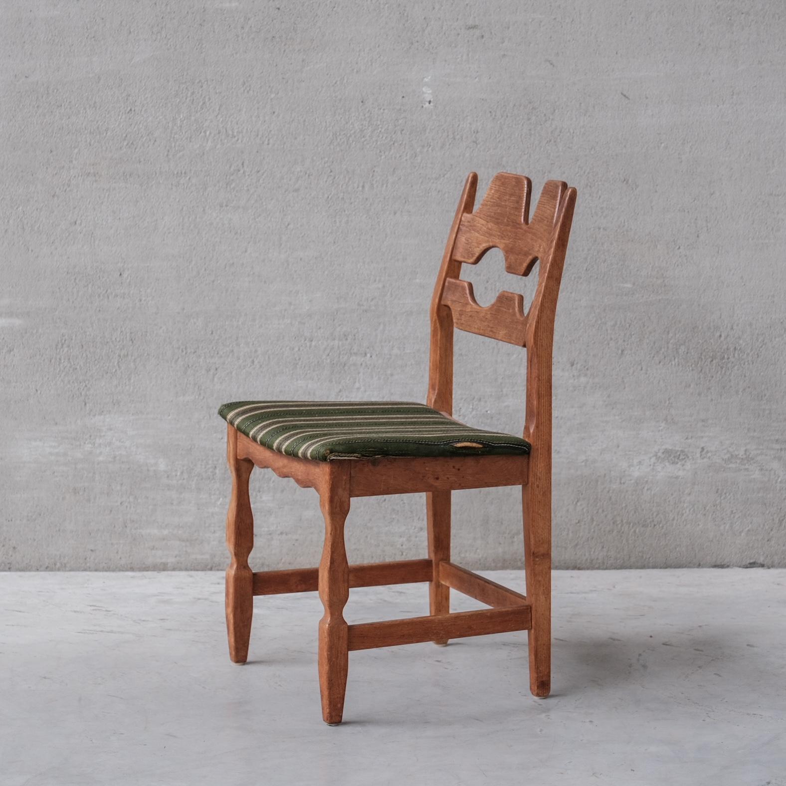 Oak dining chairs by Henning Kjaernulf. A set of Four.

Denmark, circa 1960s.

'Razor back' or 'Razor blade' model.

Original patina and finish.

Original upholstery has been retained but want's updating, the fabric is worn. We can update