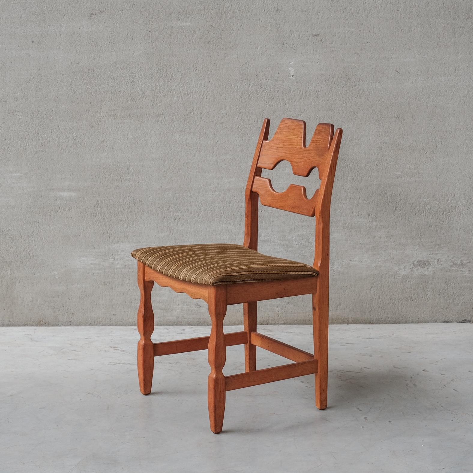 Oak dining chairs by Henning Kjaernulf. A set of six. 

Denmark, c1960s.

'Razor back' or 'Razor blade' model.

Original patina and finish.

Original upholstery has been retained but normally has signs of use and age. We can update these