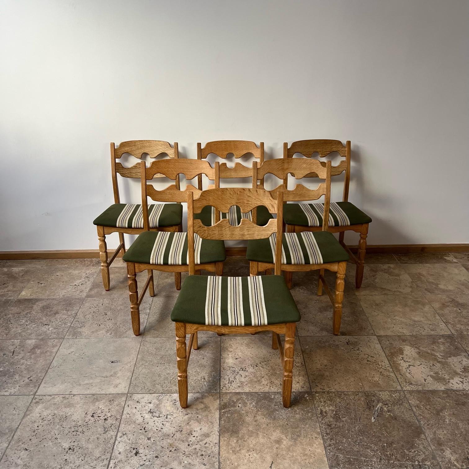 Oak dining chairs by Henning/Henry Kjaernulf. 

Denmark, c1960s. 

'Razor back' or 'Razor blade' model. 

Good condition for the wood, some wear and scuffs commensurate with age. 

The upholstery remains in good condition but can easily be changed