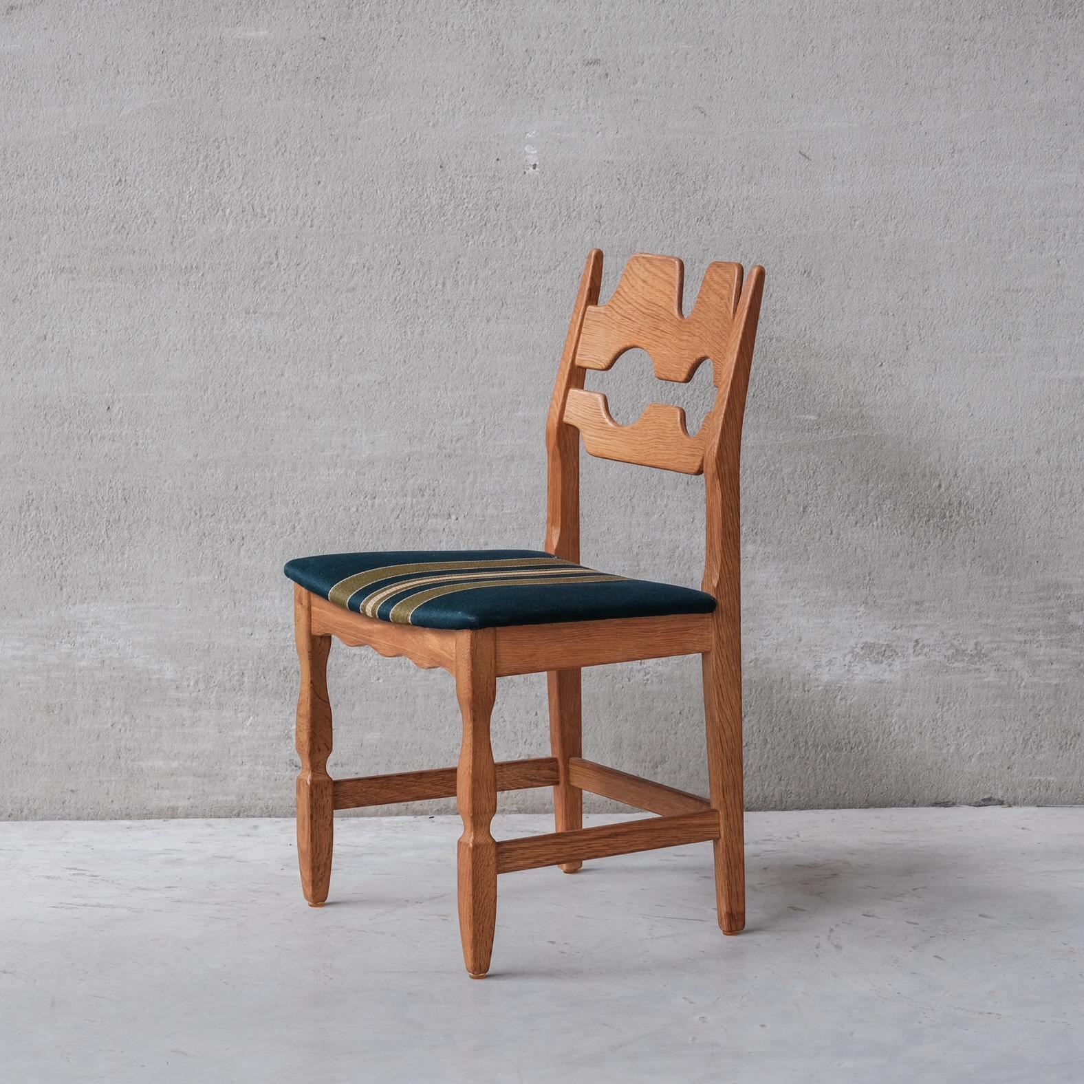Oak dining chairs by Henning Kjaernulf. A set of four. 

Denmark, c1960s.

'Razor back' or 'Razor blade' model.

Original patina and finish. 

Original upholstery has been retained but normally has signs of use and age. We can update these