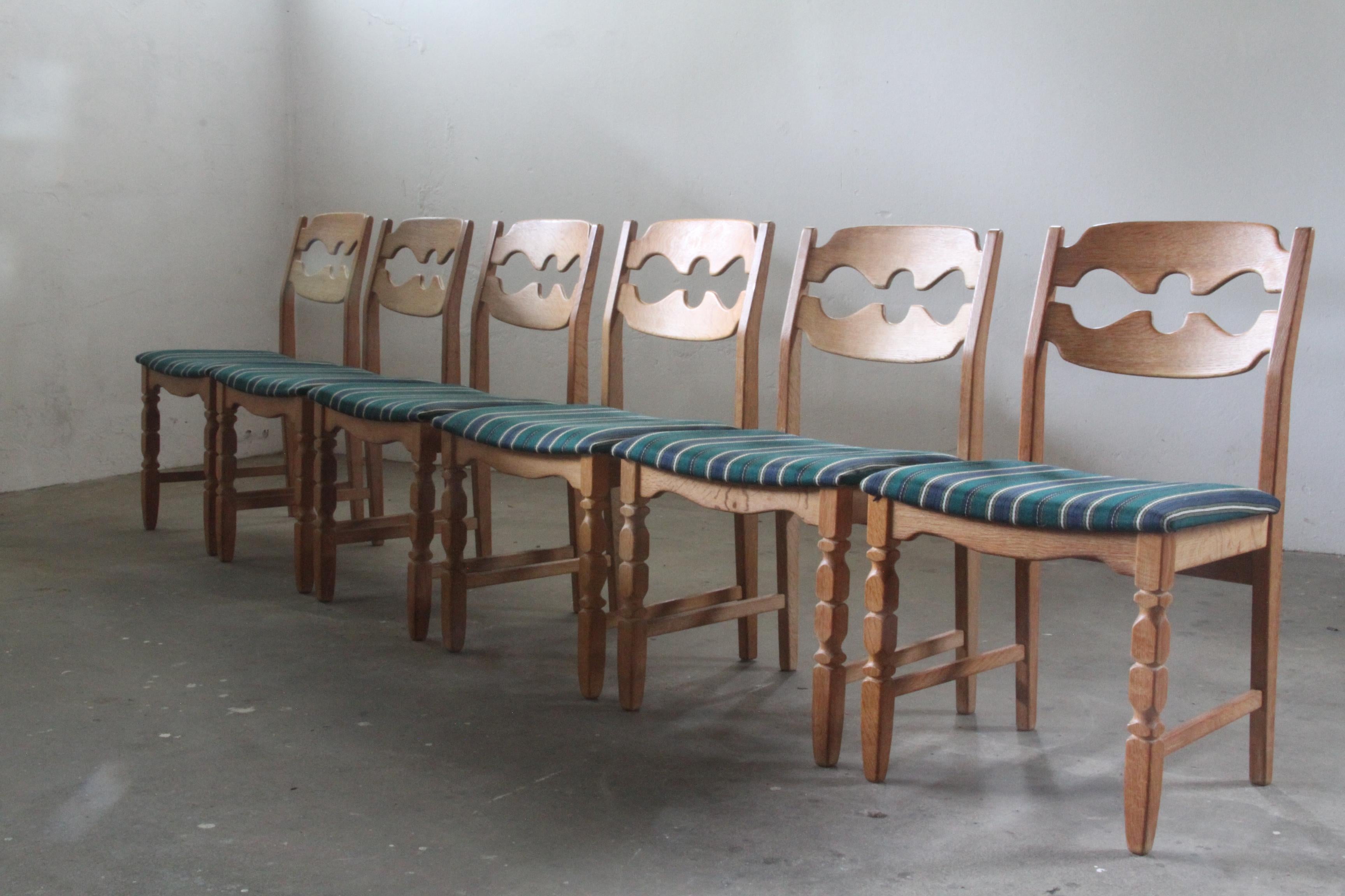 Henning Kjærnulf's striking dining chairs, crafted from oak and showcase a captivating blend of Baroque and Mid-Century Modern influences. Known as the Razorblade model, these classic chairs were produced by Nyrup Møbelfabrik during the 1960s-1970s.