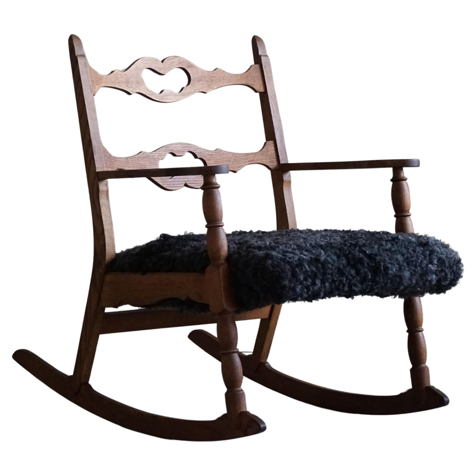 Henning Kjærnulf, Rocking Chair in Oak, Seat in Gotland Sheepskin, 1960s For Sale