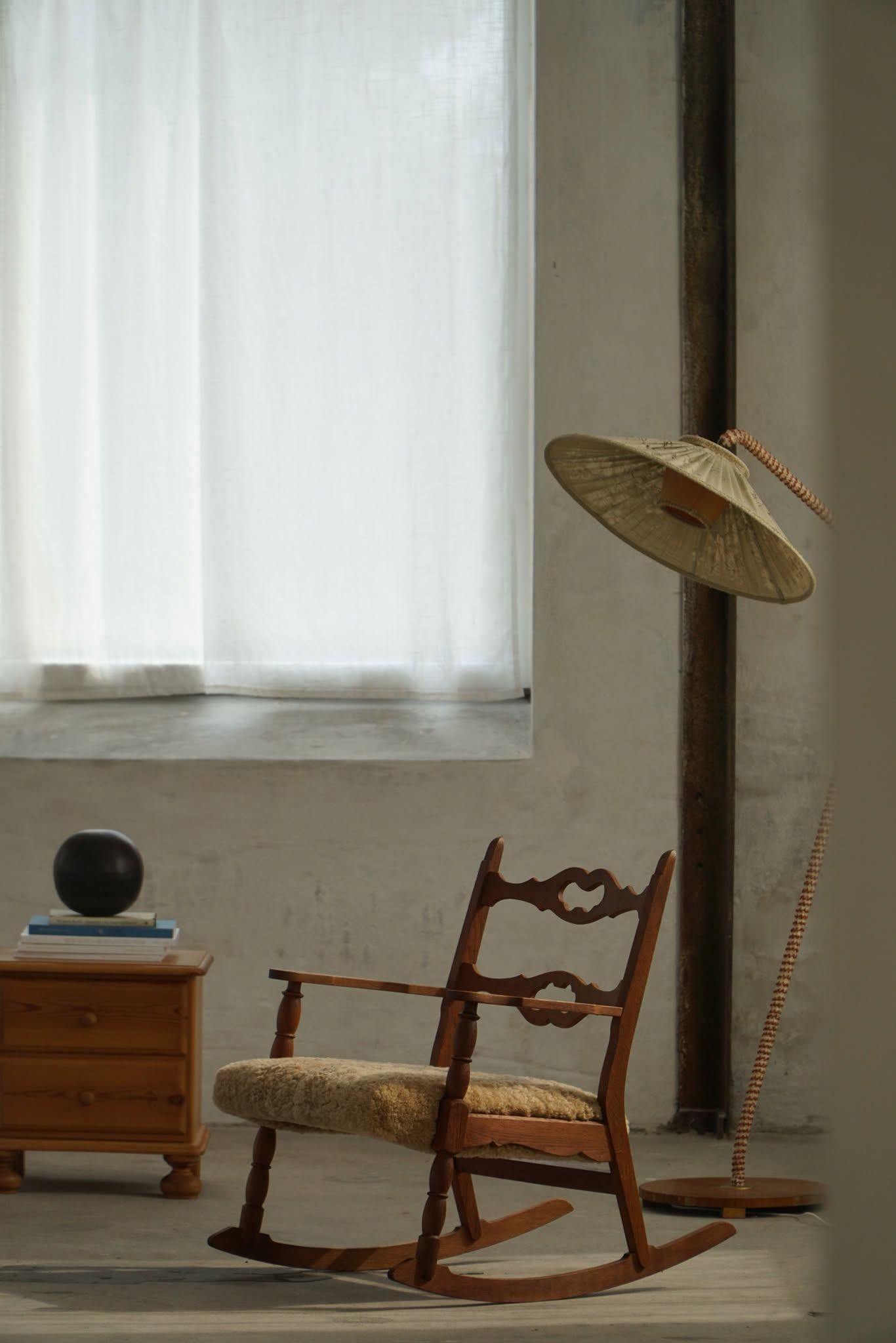 Beautiful rocking chair in solid oak, designed by Henning Kjærnulf for EG Kvalitetsmöbel in the 1960s. The chair clearly bears the mark of Kjærnulf's characteristic design language with decorative carvings and solid materials. The seat is carefully