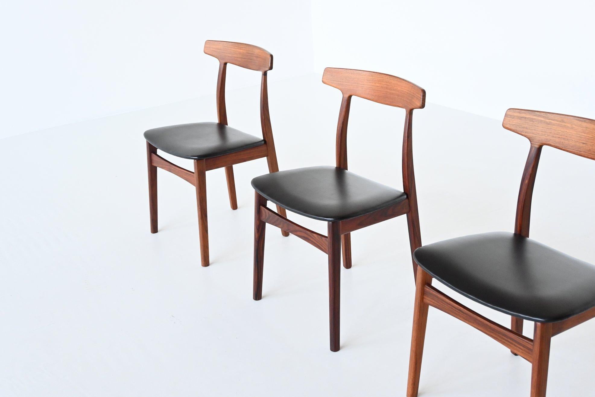 Beautiful shaped set of four dining chairs model 60 designed by Henning Kjaernulf and manufactured by Bruno Hansen, Denmark 1962. These chairs are made of beautiful grained solid rosewood and are upholstered with black faux leather. All of them are