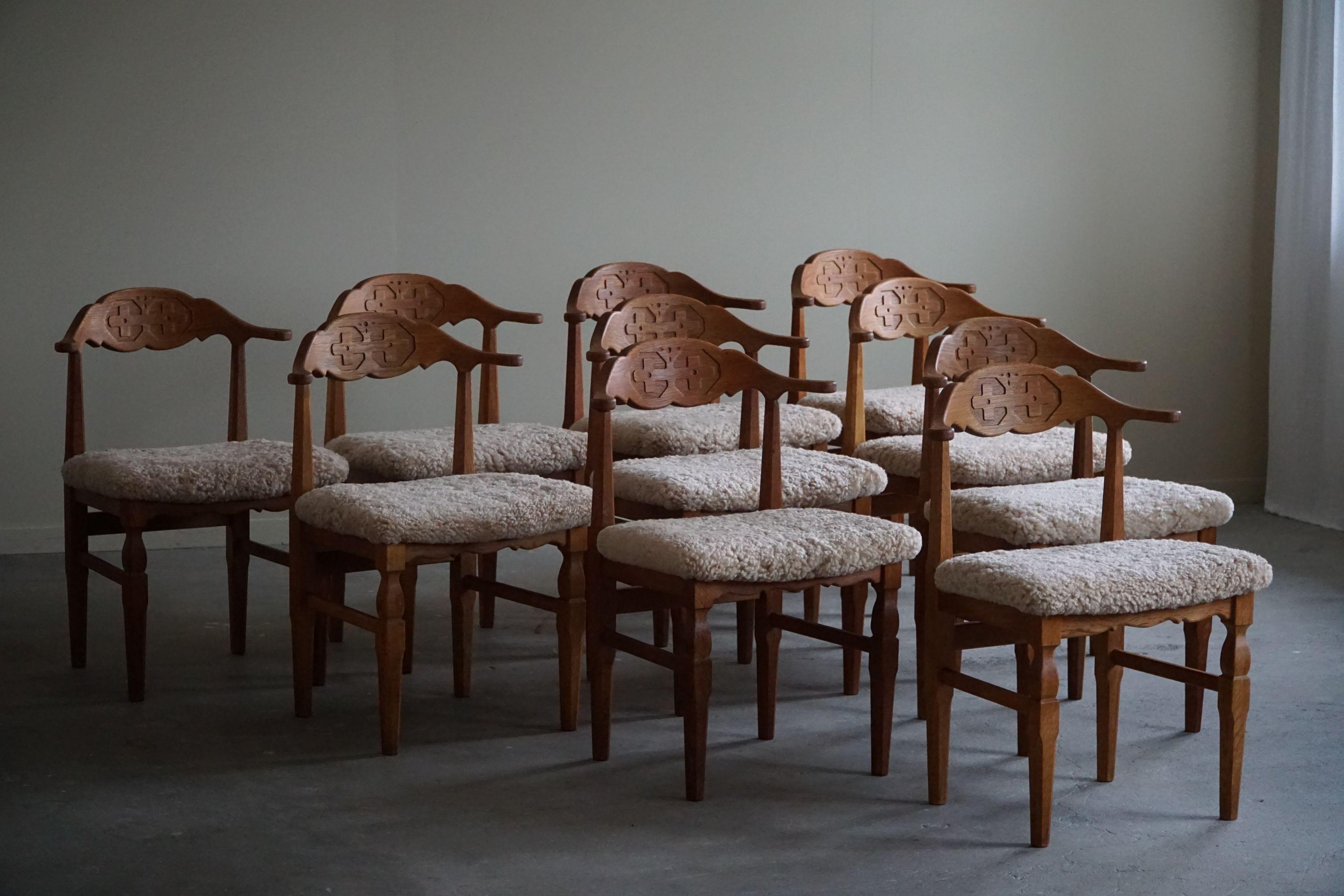 Such a magnificent set of 10 dining chairs in oak, seats reupholstered in a great quality shearling lambswool. 
Designed by Henning Kjærnulf for E.G. Møbler - made in the 1960s.

The overall impression of these mid century chairs are really