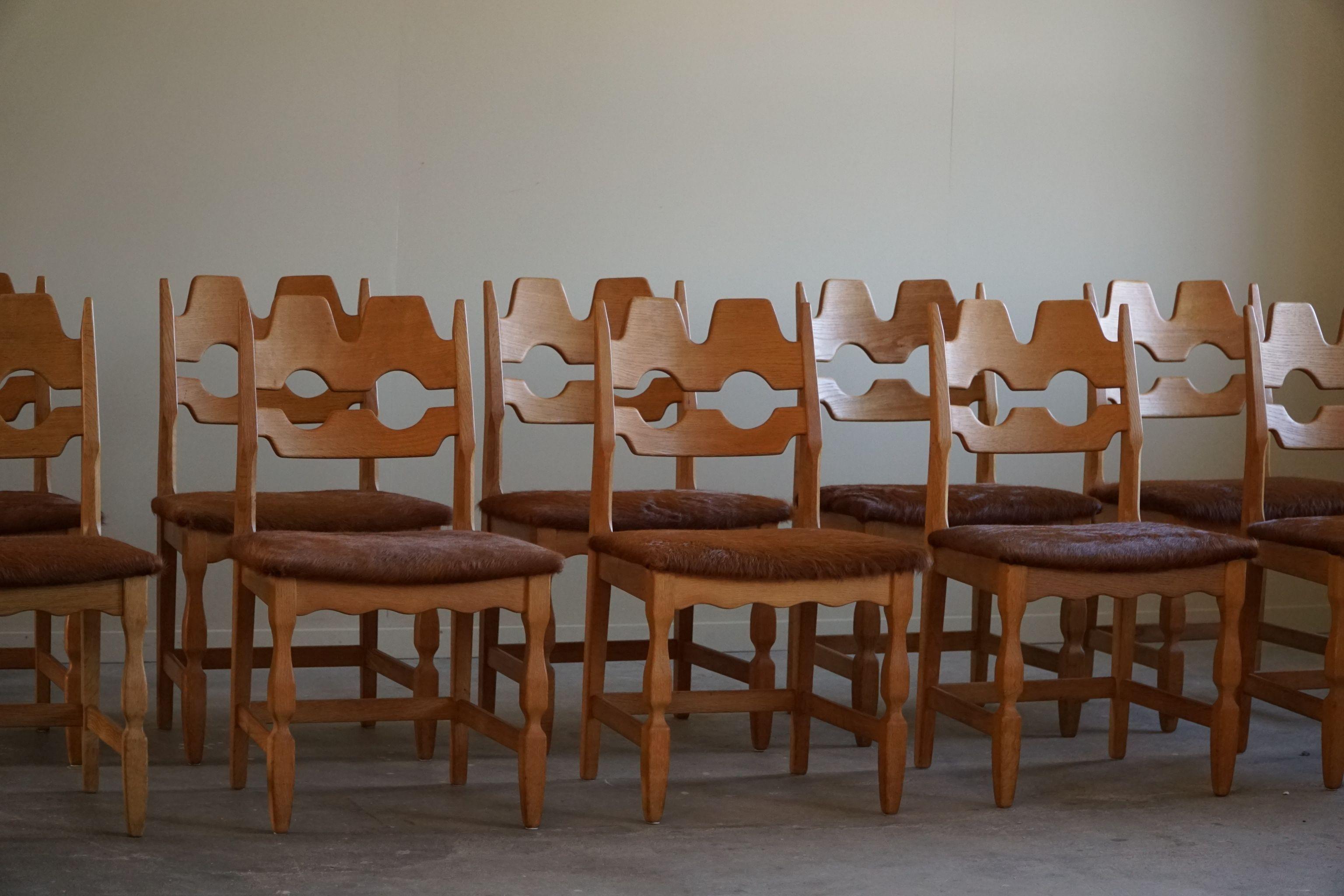 An attractive and popular sculptural set of 10 classic dining chairs in oak, seats reupholstered in great quality brown cowhide. Made by Henning (Henry) Kjærnulf for Nyrup Møbelfabrik - ca 1960s. Model 