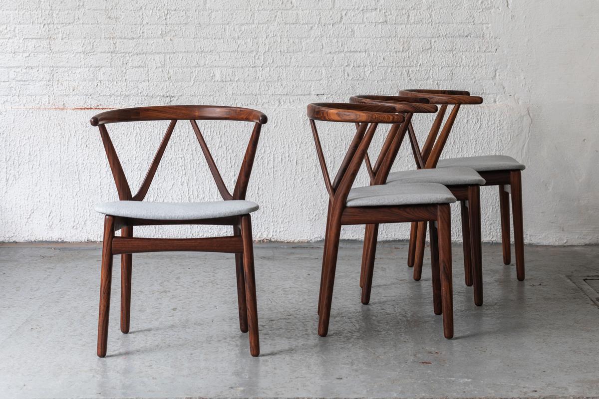 Set of 4 dining chairs designed by Henning Kjaernulf and produced by Bruno Hansen in Denmark in the 1960’s. These ‘model 225’ hoop back chairs will probably have a lot of appeal on the fans of Wegner wishbone chairs. The exquisite joinery in the