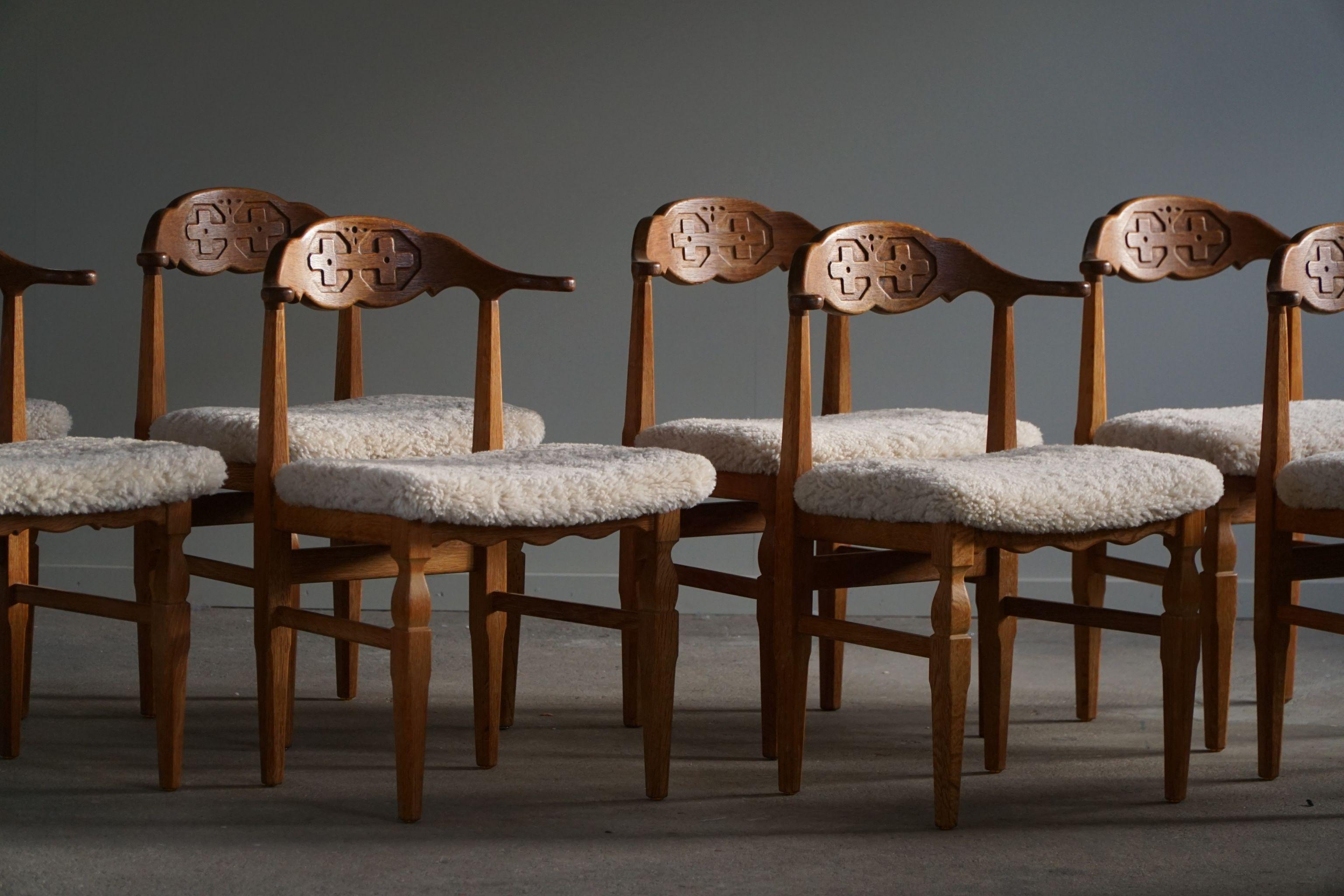 Such a magnificent set of 8 dining chairs in oak, seats reupholstered in great quality shearling lambswool. Strong references to the other popular 
