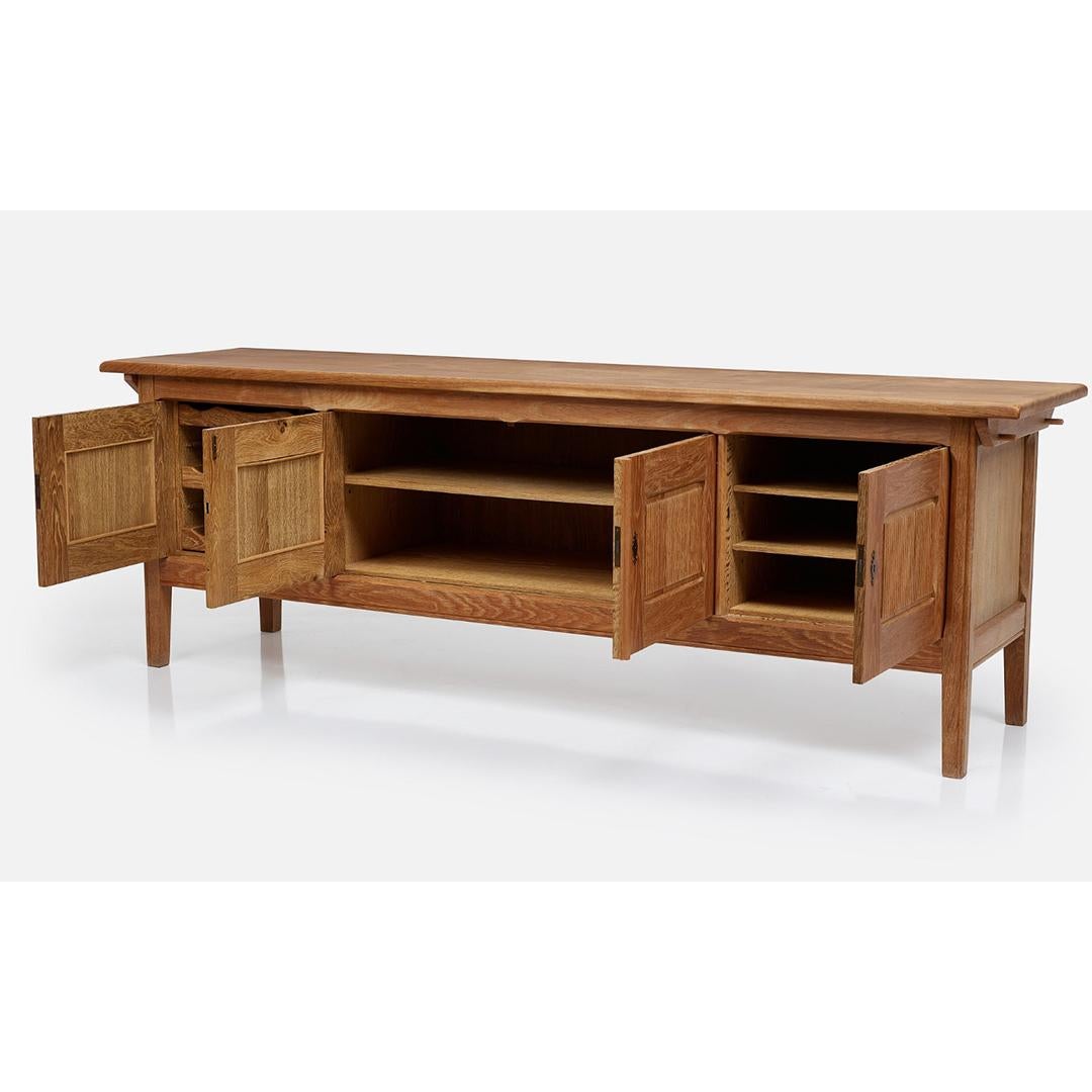 A 1960’s Swedish sidebaord by Henning Kjaernulf manufactured by EG Kvalitetsmobel. Crafted from rich oak, this sideboard exhibits the warmth and natural beauty of the material, while its sleek and minimalist lines exemplify the quinessential