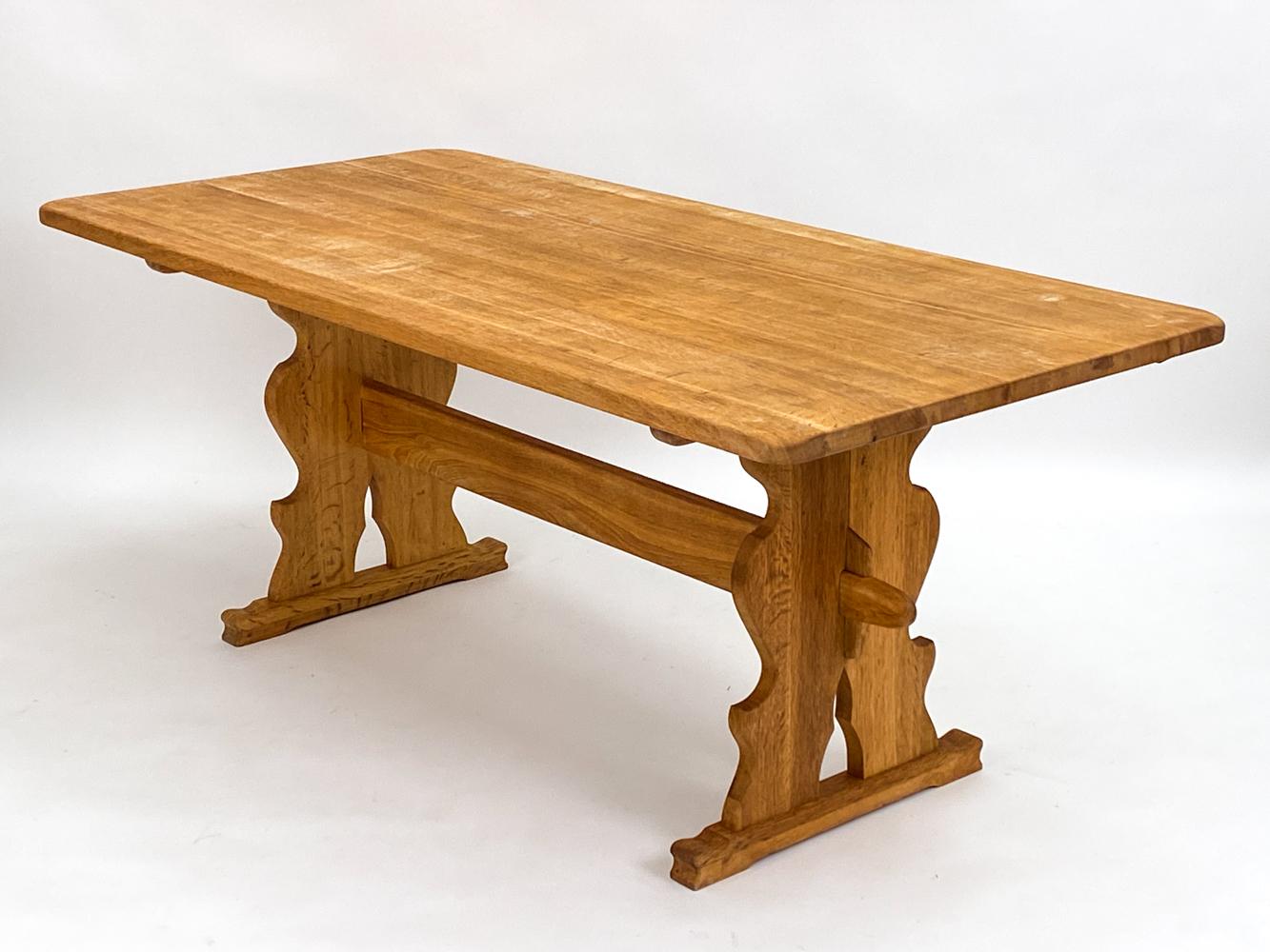 Embrace the rustic charm and sophisticated design of this Henning Kjaernulf-style provincial farmhouse trestle dining table. Echoing the essence of Danish mid-century artistry, this table is a celebration of both tradition and innovation, where