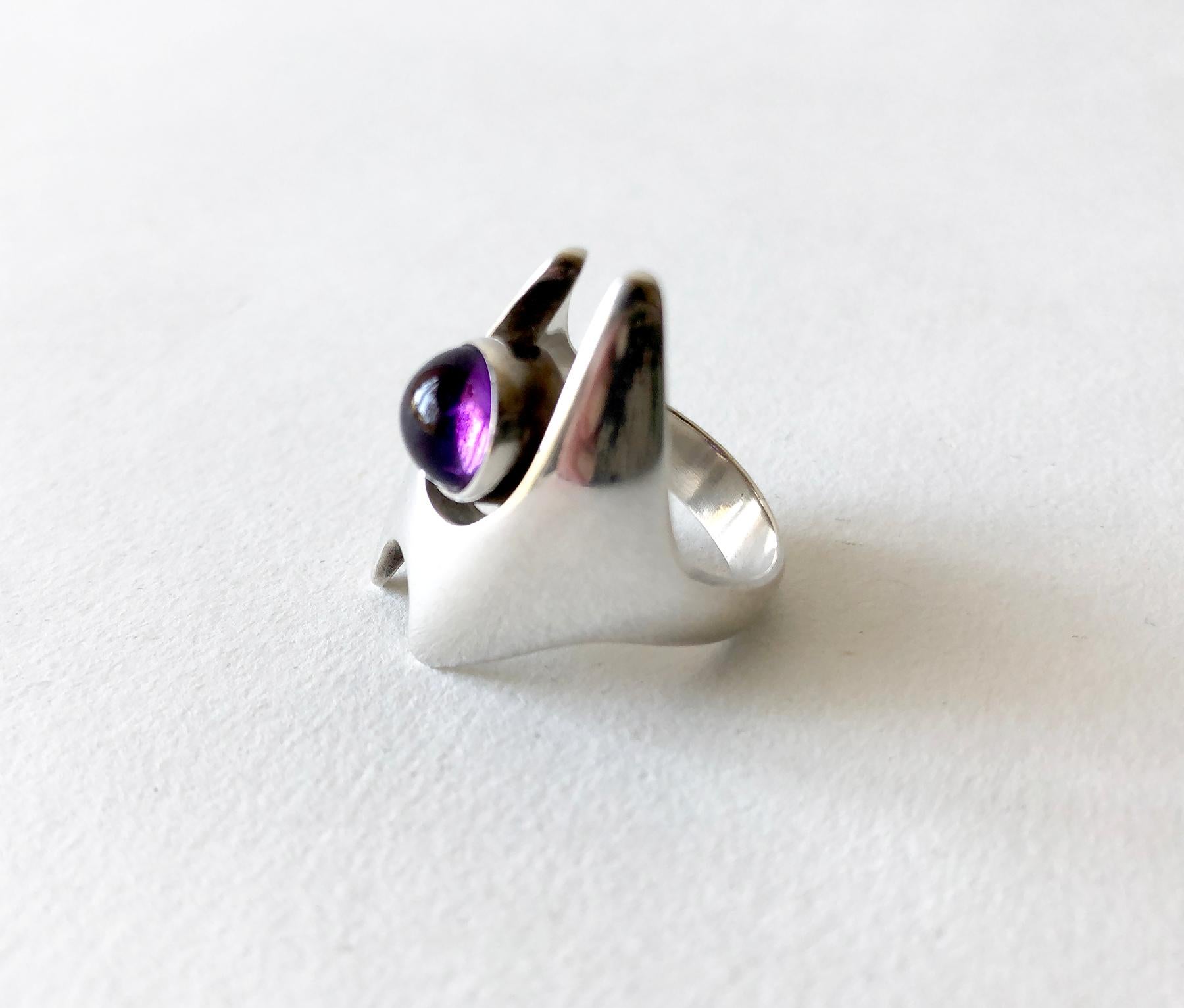 1960s Danish modernist sterling silver and amethyst cabochon ring created by Henning Koppel for Georg Jensen.  Ring is a finger size 7.5 and is signed Georg Jensen, 925, 139, Denmark.  In very good vintage condition.