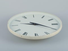 Henning Koppel for Georg Jensen. Wall clock made of white plastic and metal.