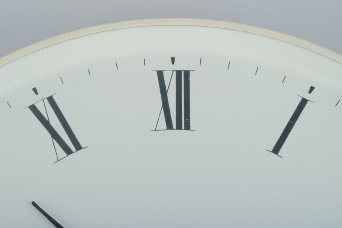 Danish Henning Koppel for Georg Jensen. Wall clock made of white plastic and metal. For Sale