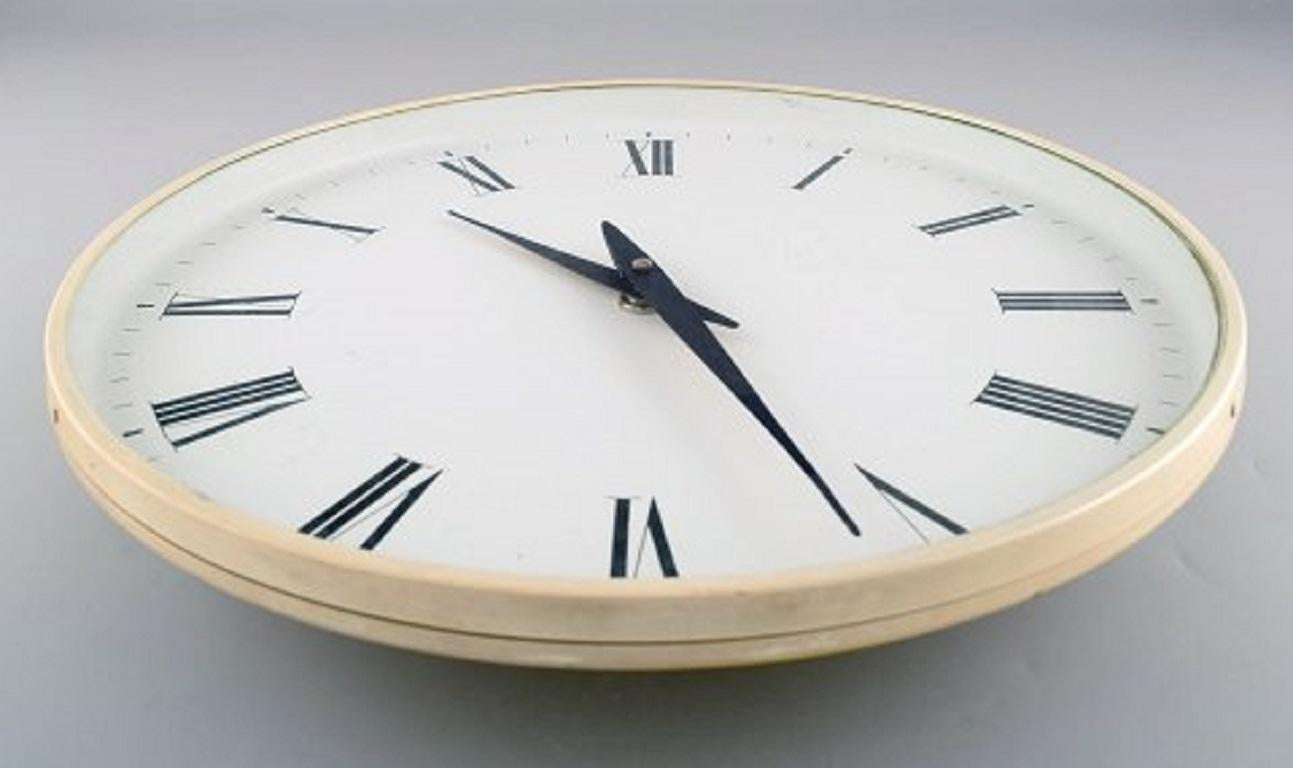 Henning Koppel for Georg Jensen. White plastic wall clock. Dial with Roman numerals. Clockwork quartz, 1960s-1970s.
Measures: Diameter 40 cm.
In very good condition.