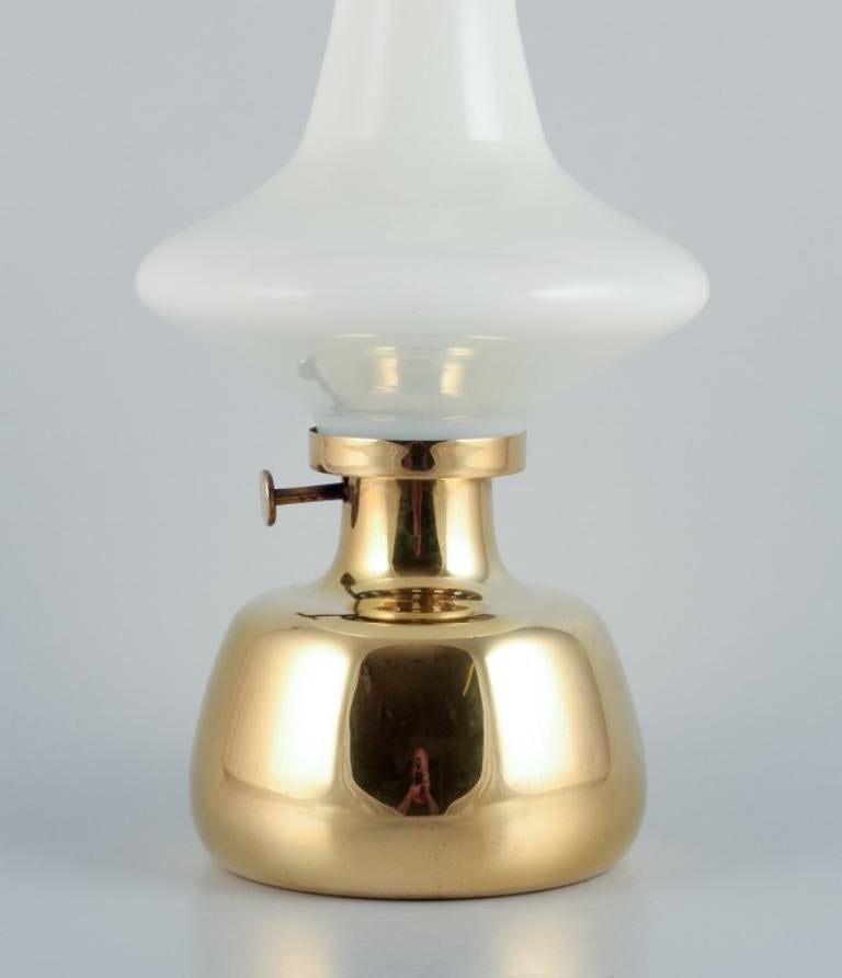 Henning Koppel for Louis Poulsen. 
Petronella oil lamp in brass with an opal glass shade.
Designed in 1961.
In perfect condition.
Dimensions: H 32.0 cm x D 17.0 cm.
