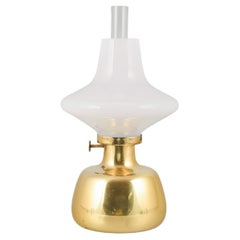 Henning Koppel for Louis Poulsen. Petronella oil lamp in brass and opal glass. Henning Koppel for Louis Poulsen. Petronella oil lamp in brass and opal glass.