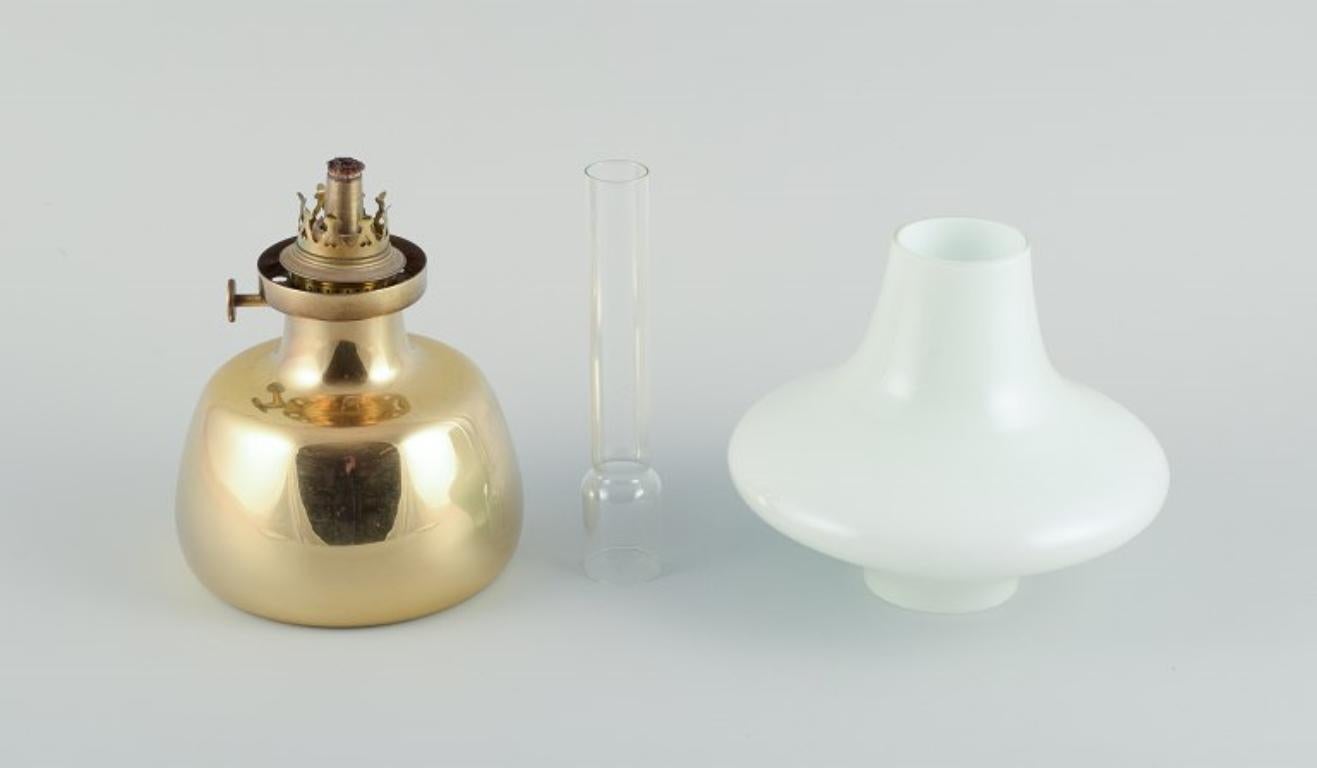20th Century Henning Koppel for Louis Poulsen. Petronella oil lamp in brass with glass shade